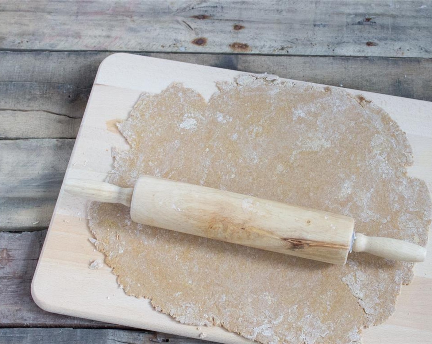 step 2 Using a floured rolling pin, roll out dough as thin as you can get it on a floured surface. If it's sticking, add a little more flour.