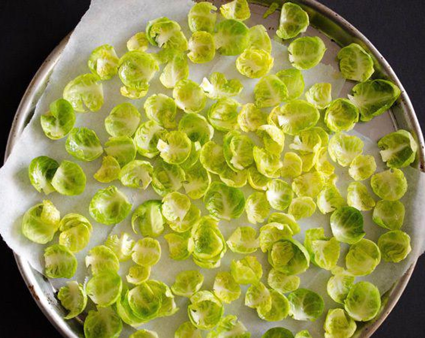 step 2 Clean Brussels Sprouts (15) well, then separate the leaves by trimming off the stem. Pluck off leaves then trim more of the stem as needed until you separated as many leaves as possible. Toss leaves with Olive Oil (1/2 Tbsp), Lemon (1/4), Salt (to taste) and Ground Black Pepper (to taste), using your fingers to work the oil into the leaves. Spread onto a lined sheet and bake at 350 degrees F (180 degrees C) for 7 to 10 minutes, until the edges of the leaves begin to brown.