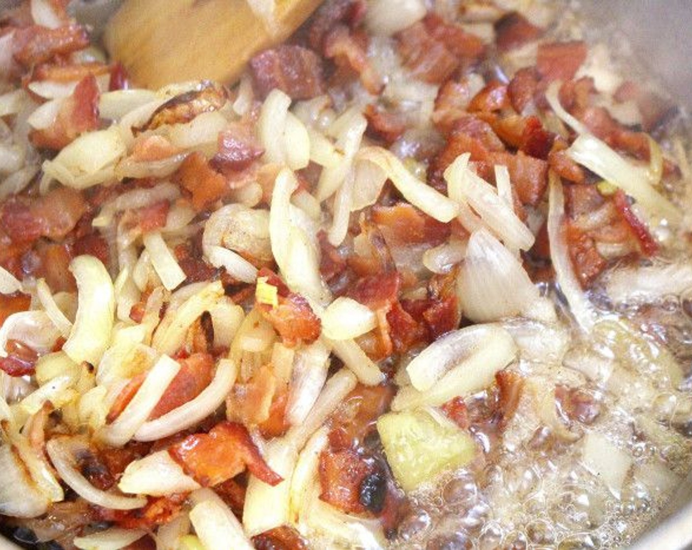 step 6 Slice the Bacon (14 oz) into small pieces and saute until crisp. Add the sliced Onions (2) and sauté until the onions are opaque.