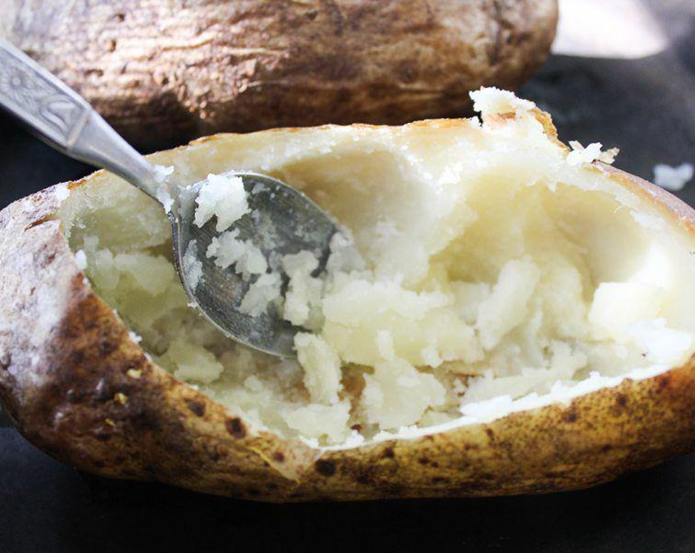 step 4 When potatoes are done, cut a large wedge into each potato. Carefully scoop out the insides, leaving a "potato bowl." Reserve potato insides for another use.