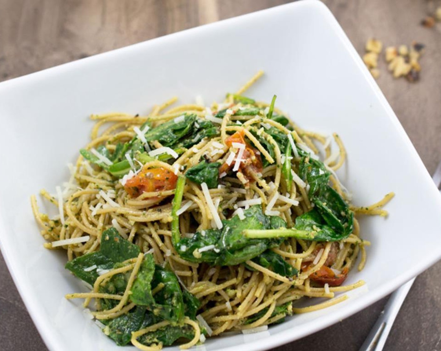 step 8 When the pasta is done, drain and immediately put it back into the pan. Toss with the Spinach and Arugula Mix (225 g). Fold in the pesto, roasted tomatoes, and ¼ cup parmesan cheese and season with Salt (1/2 tsp) and Ground Black Pepper (1/4 tsp).