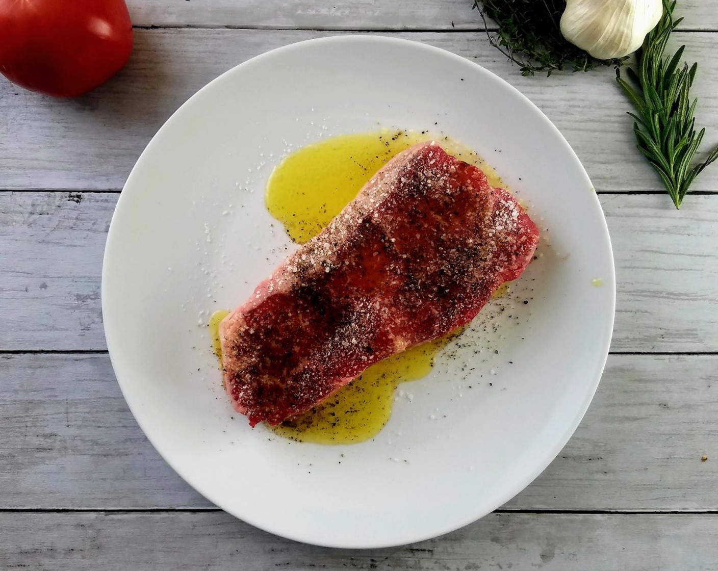 step 2 Season the Sirloin Steak (8 oz) with Extra-Virgin Olive Oil (1 Tbsp), Salt (1 tsp), and Ground Black Pepper (1 tsp).