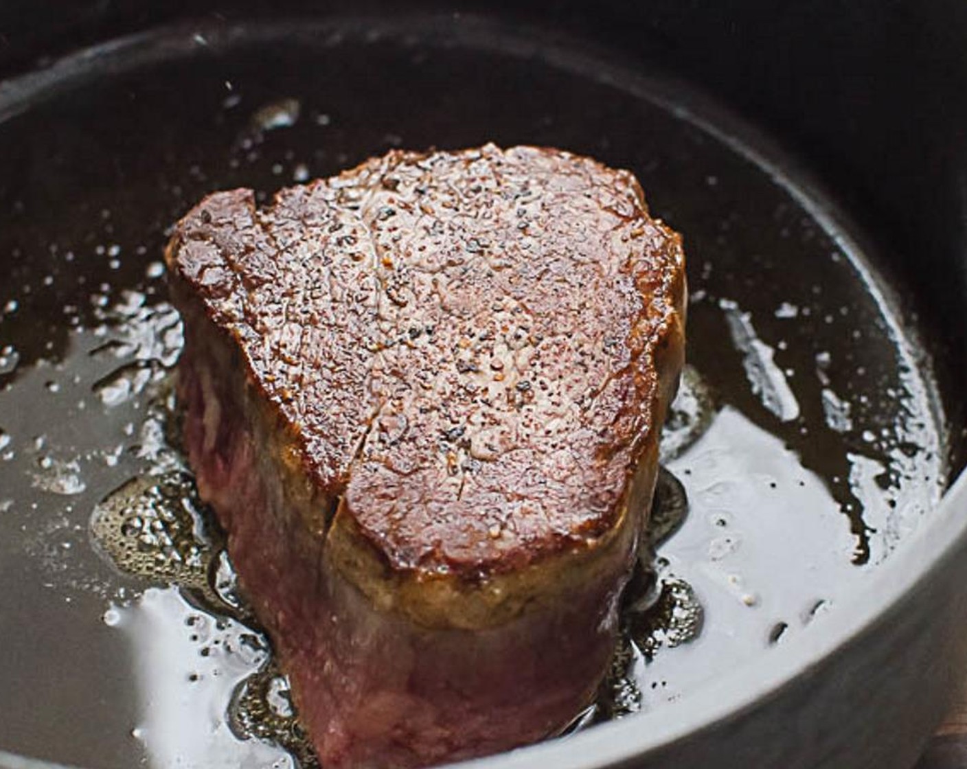 step 10 In the same skillet, heat the Butter (1 Tbsp) over high heat until foamy and add the steaks to the skillet. Sear the meat on one side for about 2 minutes.