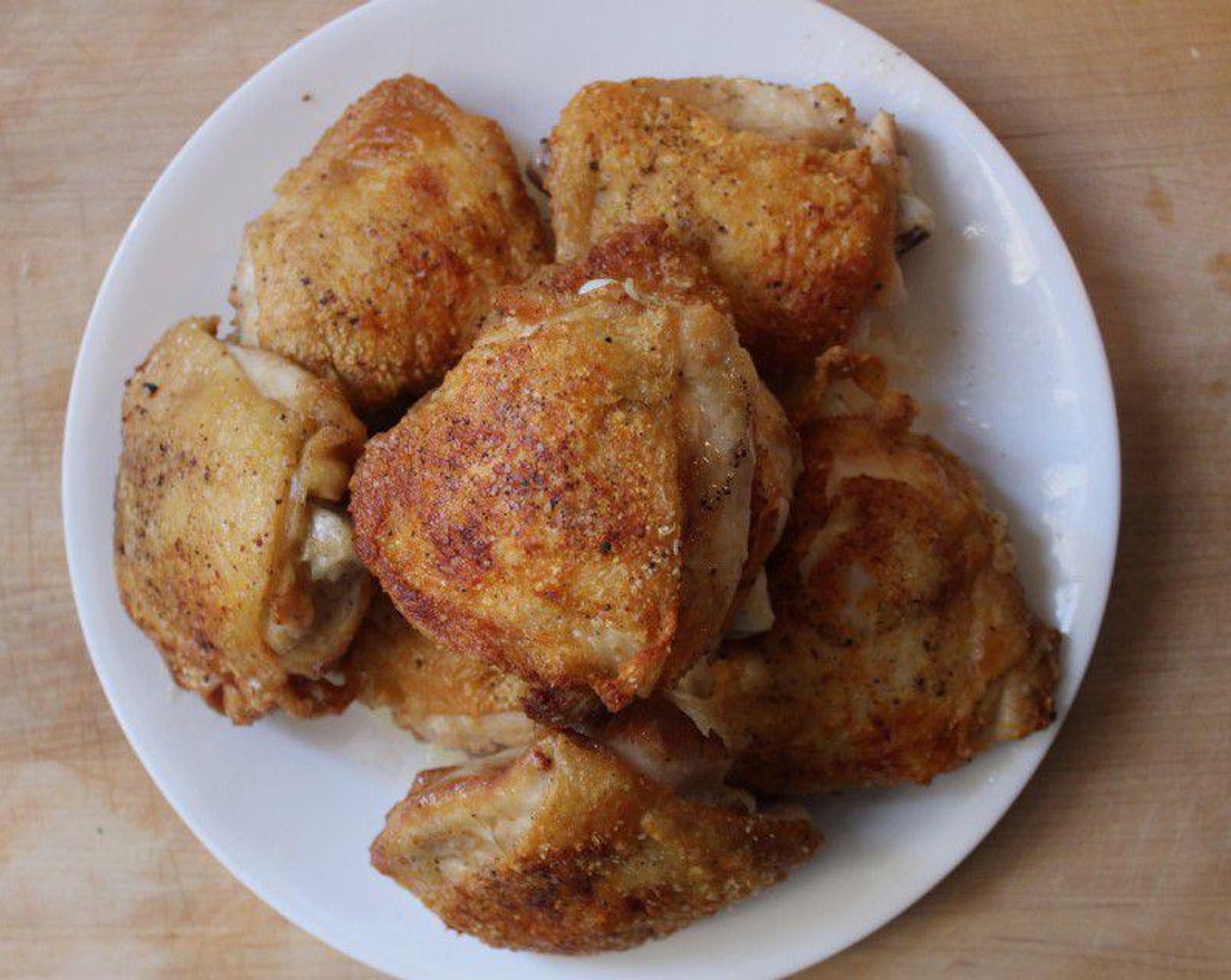 step 2 In a medium (11-inch) Dutch oven, heat the Extra-Virgin Olive Oil (2 Tbsp) over medium-high heat. Pat the Bone-in, Skin-on Chicken Thighs (8) dry with paper towels and sprinkle both sides liberally with Kosher Salt (to taste) and Freshly Ground Black Pepper (to taste).