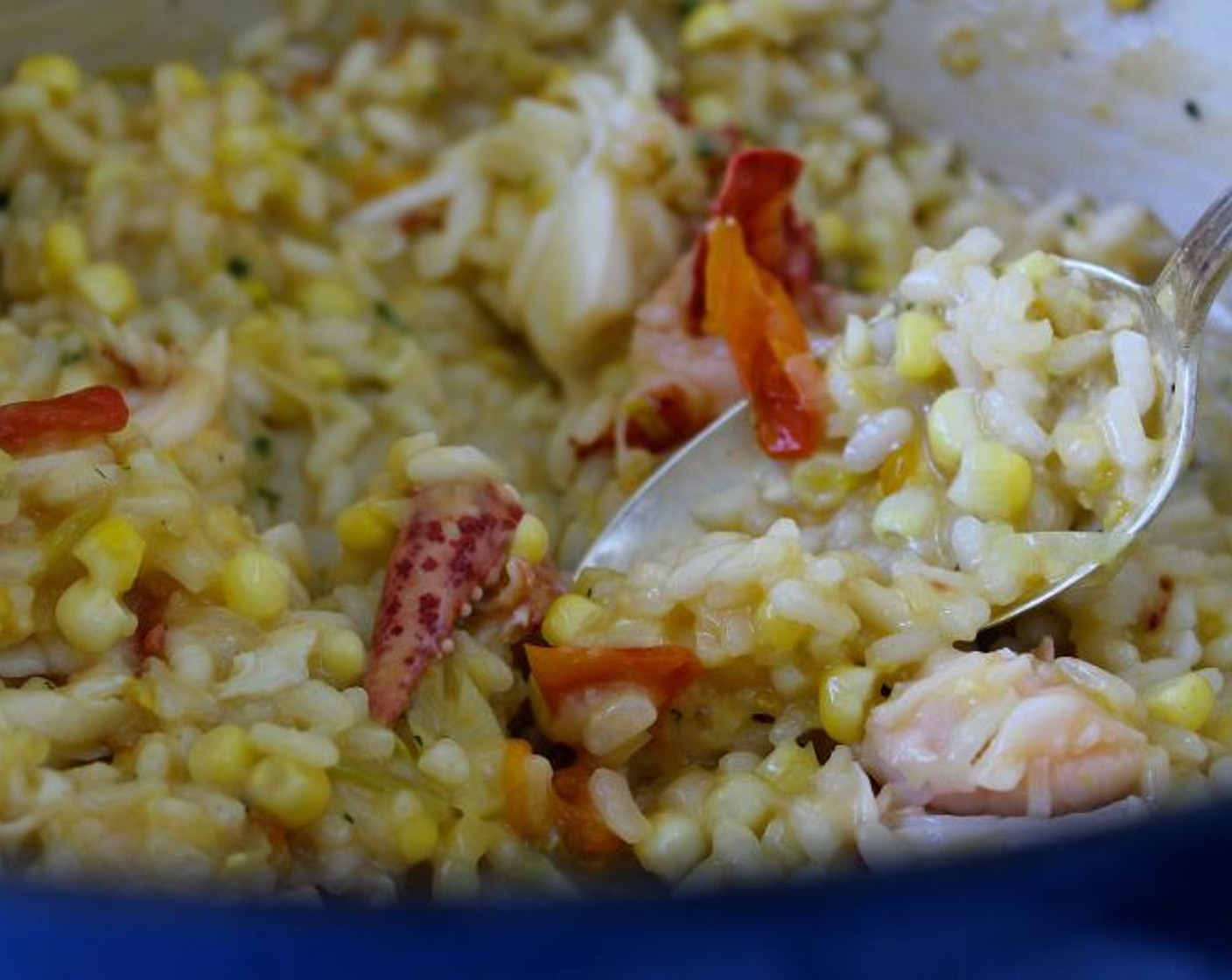 step 7 When the risotto has been cooking for 15 minutes, add the Cherry Tomatoes (1 1/2 cups), corn, Kosher Salt (1/2 Tbsp), and Ground Black Pepper (1/2 tsp). Continue cooking and adding stock, stirring almost constantly, until the rice is tender but still firm.