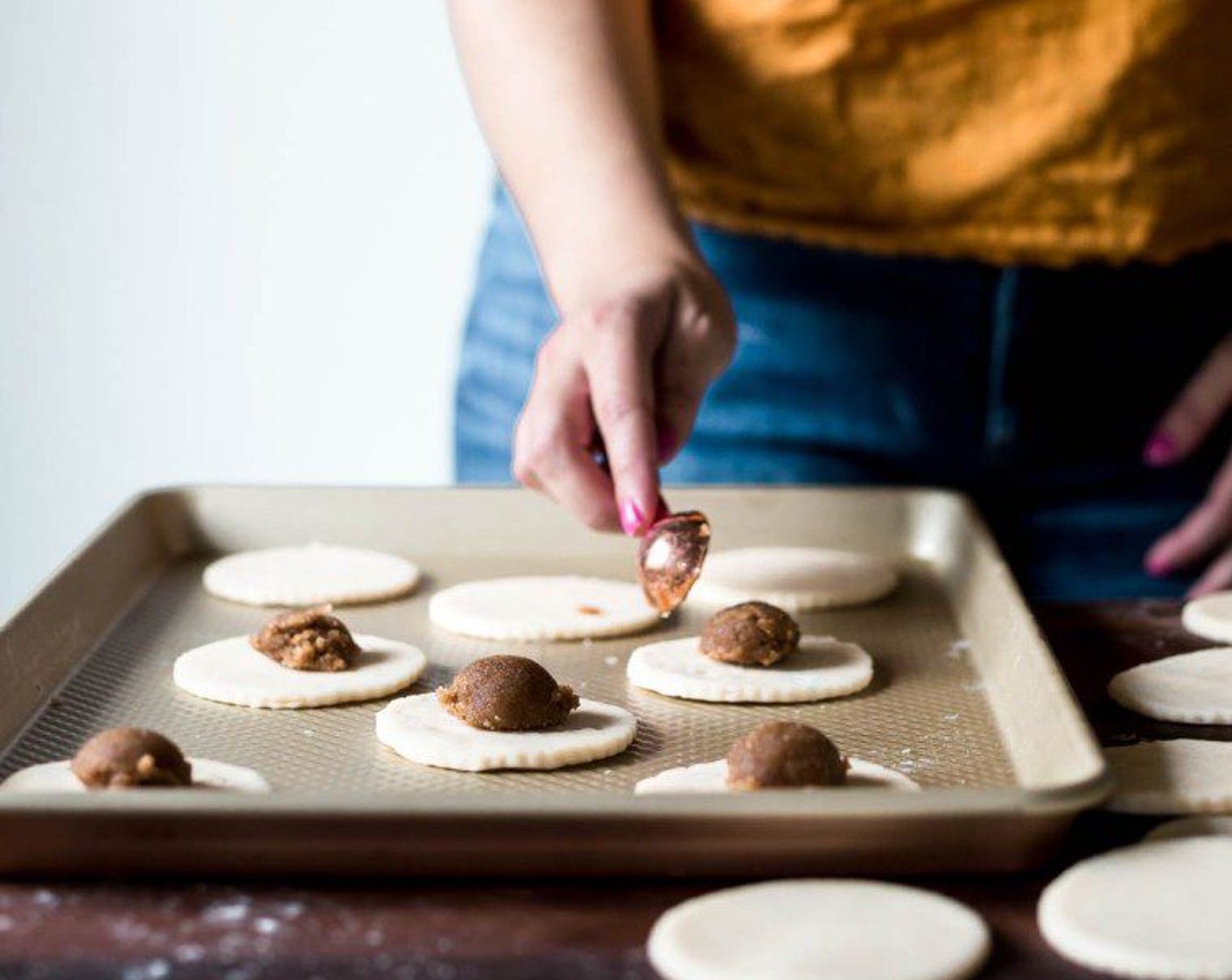 step 10 Place an overflowing tablespoon of the brown sugar mixture into the center of half the dough disks.