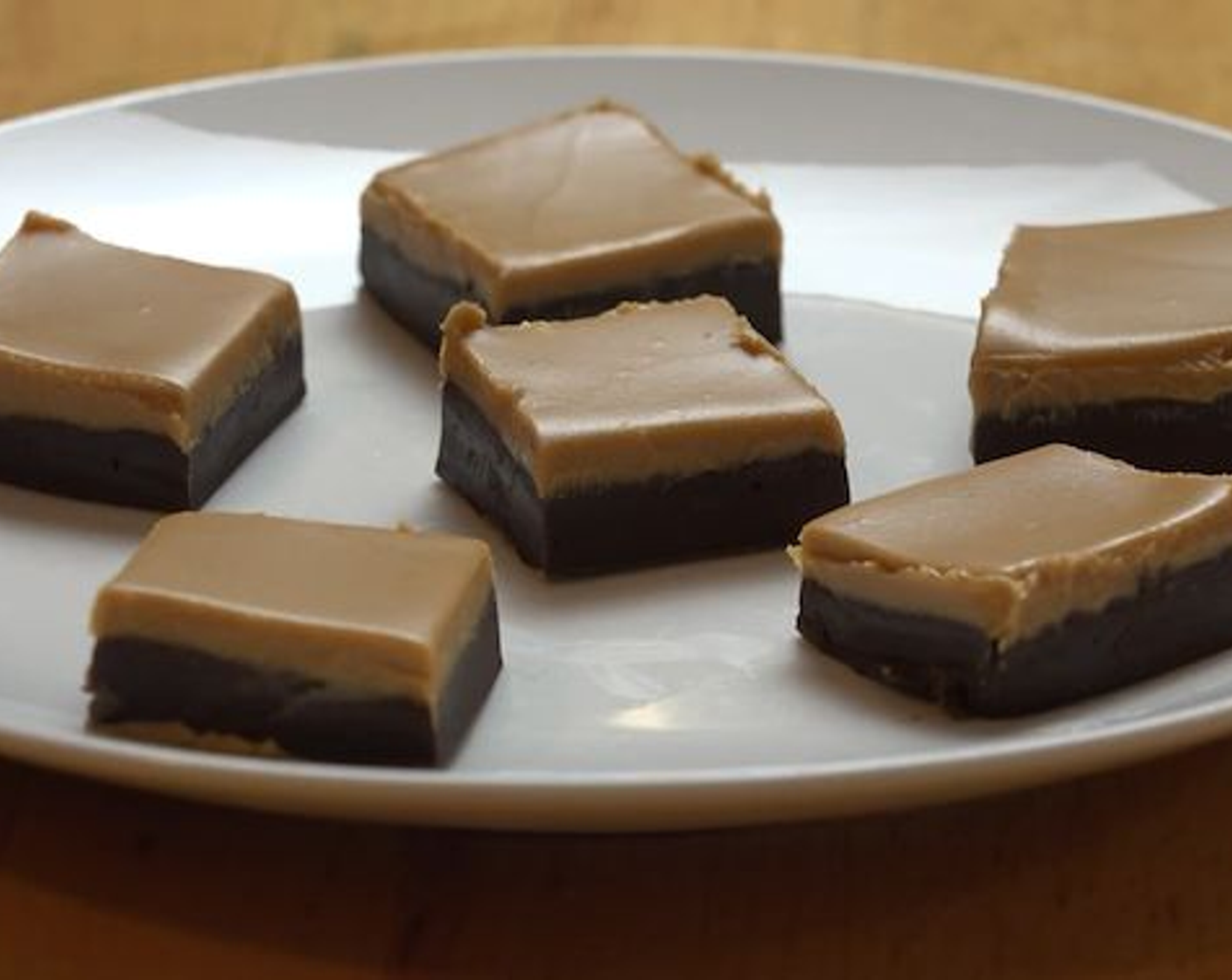 step 5 Place back into the fridge for 4 hours or until the chocolate has set. When ready, gently pull out of the cake pan using the longer parchment paper ends, and cut the fudge into square. Serve and enjoy!