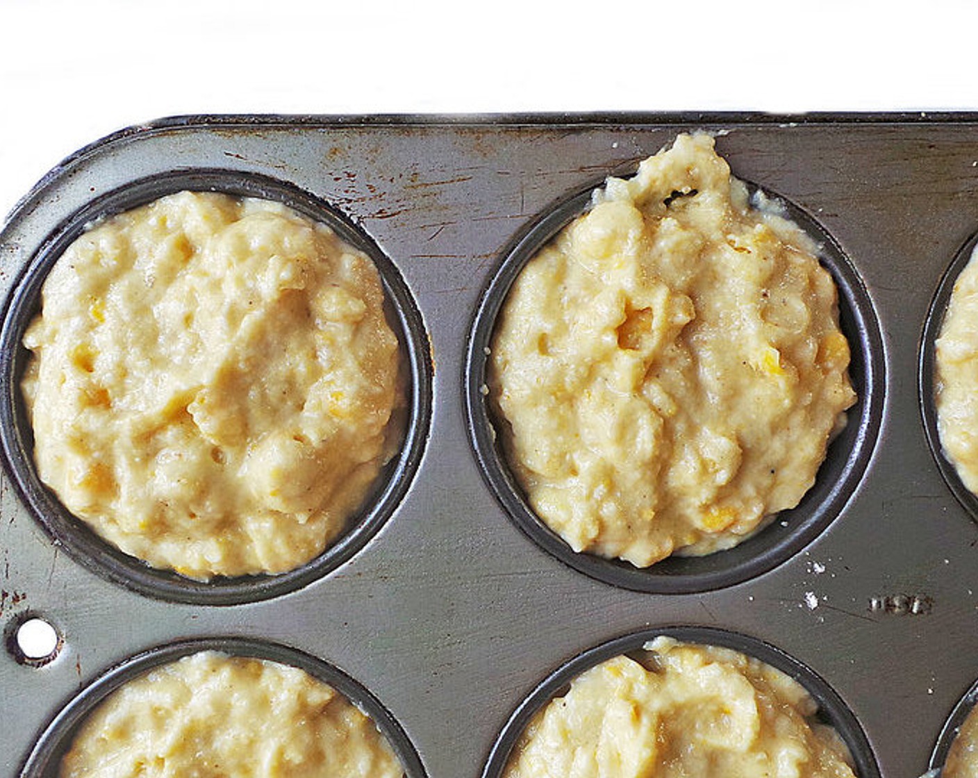 step 4 Scoop batter evenly into each muffin cup, filling to the top for some mega muffins!