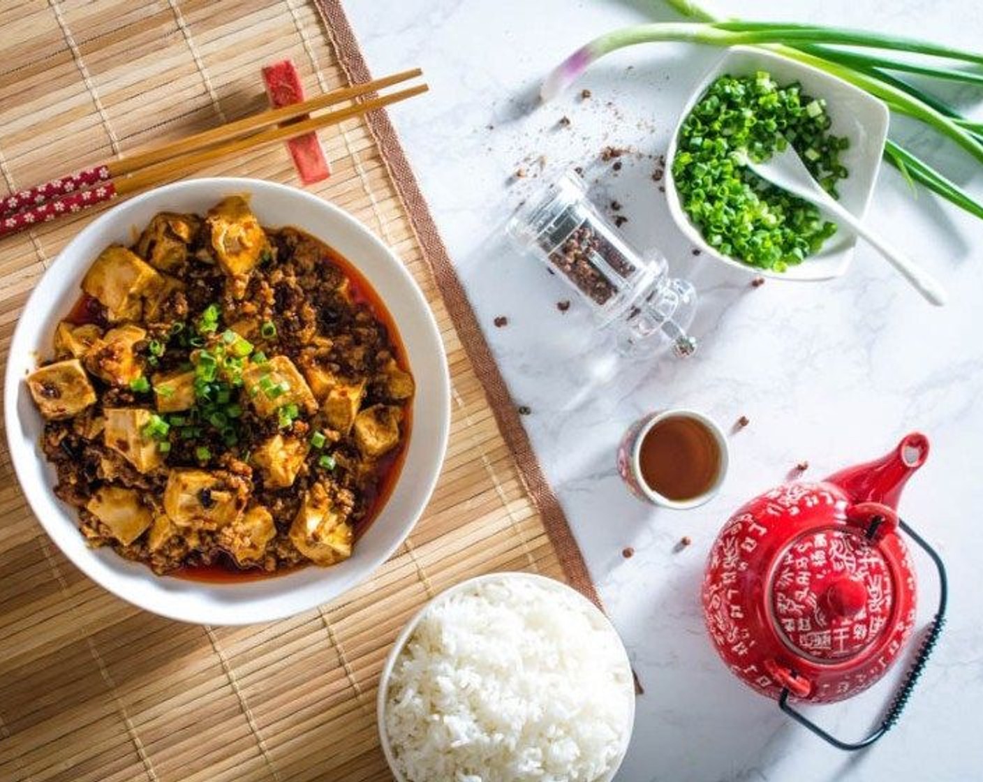 step 8 Transfer to a serving dish. Garnish with Ground Sichuan Pepper (to taste) and Scallion (1/2 cup). Serve alongside White Rice (to taste).