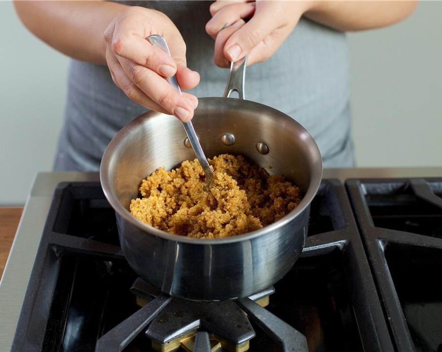 step 1 In a small saucepan over medium high heat, bring one and a half cups of water to boil. Add Black Bean Quinoa (1 pckg) and return to a boil. Reduce heat to low, cover, and let simmer for 15 minutes. Remove from heat, fluff, and keep warm for plating.