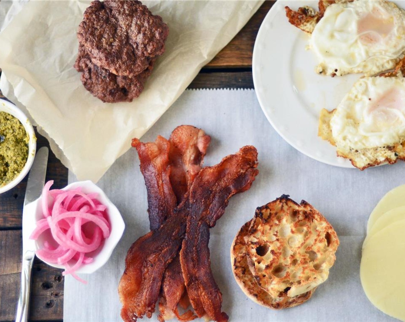 step 2 Moments before your burger is done grilling, place Provolone Cheese (1 slice) atop of the grilled hamburger patty and allow to melt. Toast the English Muffin (1).