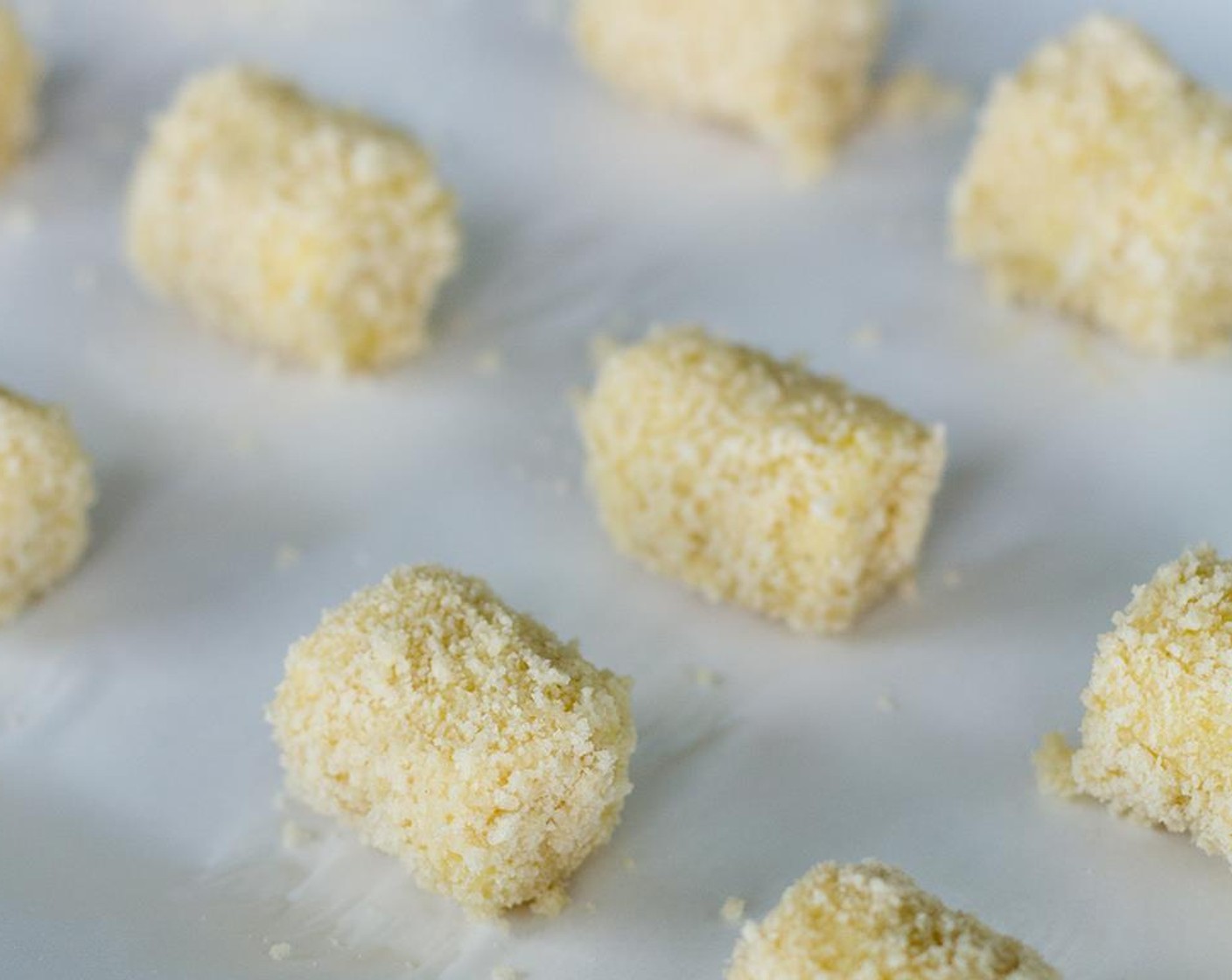 step 9 To coat the tots, dunk each tot first in to the egg wash, then roll the coated tot in the Panko crumbs until covered, then place back on to the baking sheet.