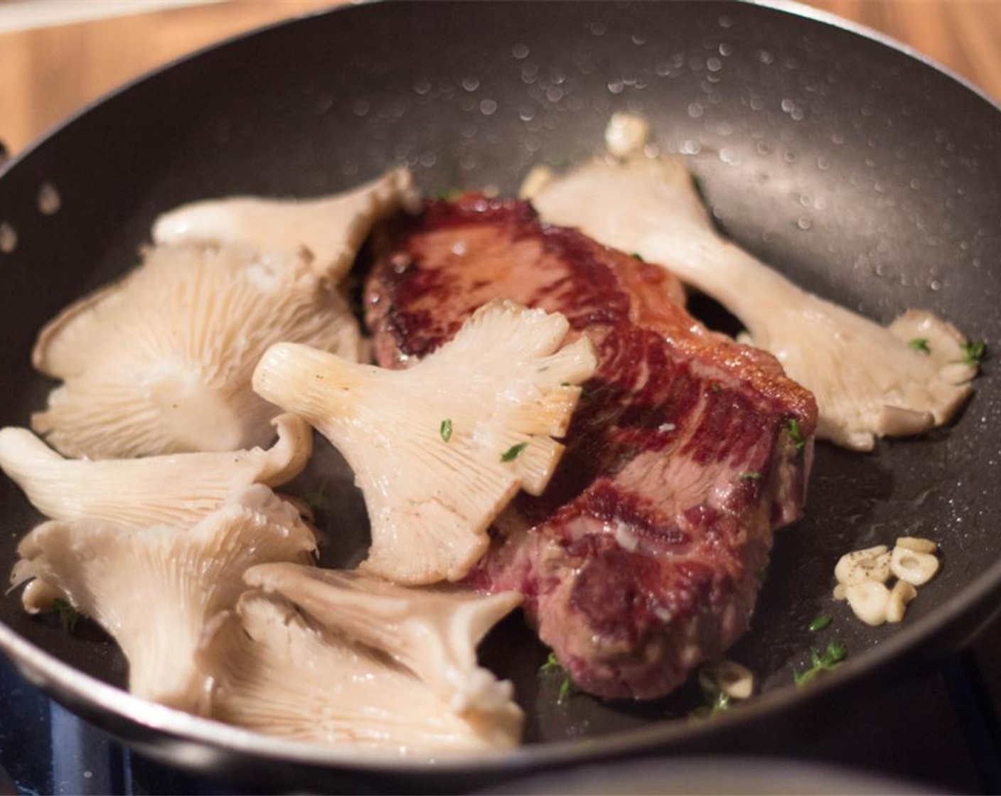 step 5 Add the Chanterelle Mushrooms (9 1/4 cups) and Fresh Thyme (to taste) when you flip the tenderloins. Cut the Garlic (1 clove) into small slices and add to the frying pan.