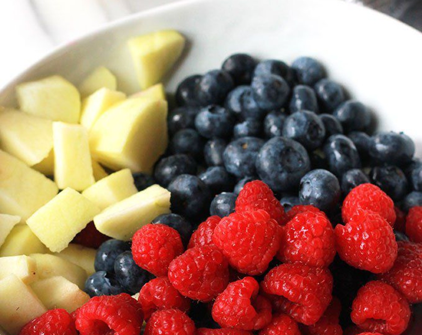 step 9 While the crust is baking, mix together the Fresh Blueberries (1 1/4 cups), Fresh Raspberries (1 1/4 cups), Granny Smith Apples (2), zest and juice from Lemon (1), Maple Syrup (2 Tbsp), Agave Syrup (to taste) and All-Purpose Flour (2 Tbsp) in a large bowl.