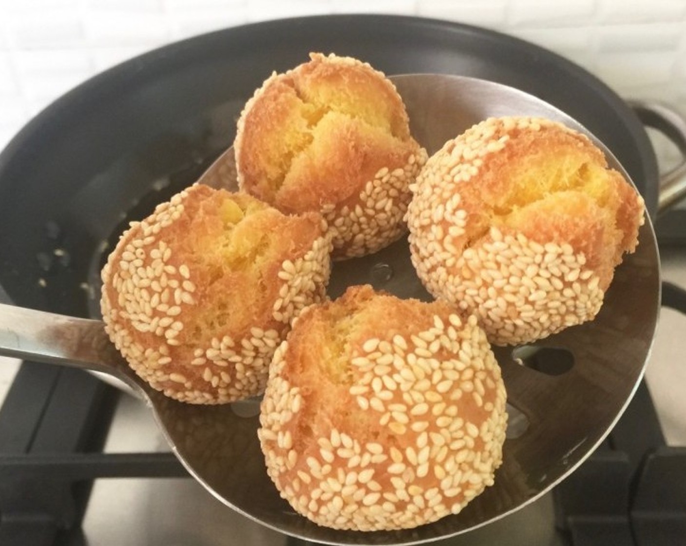 step 17 When done, remove the dough balls from the oil using a strainer.