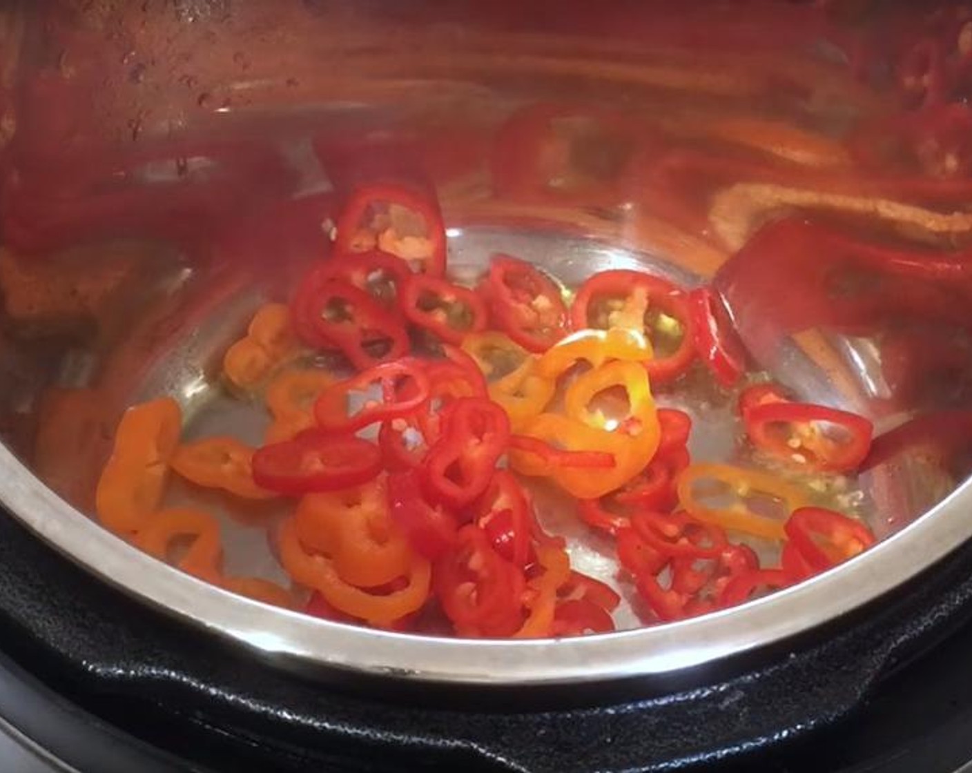 step 1 Into the pressure cooker, pour Olive Oil (as needed). Add Bell Peppers (1 1/2 cups) and Onion (1). Let it cook for one or two minutes.