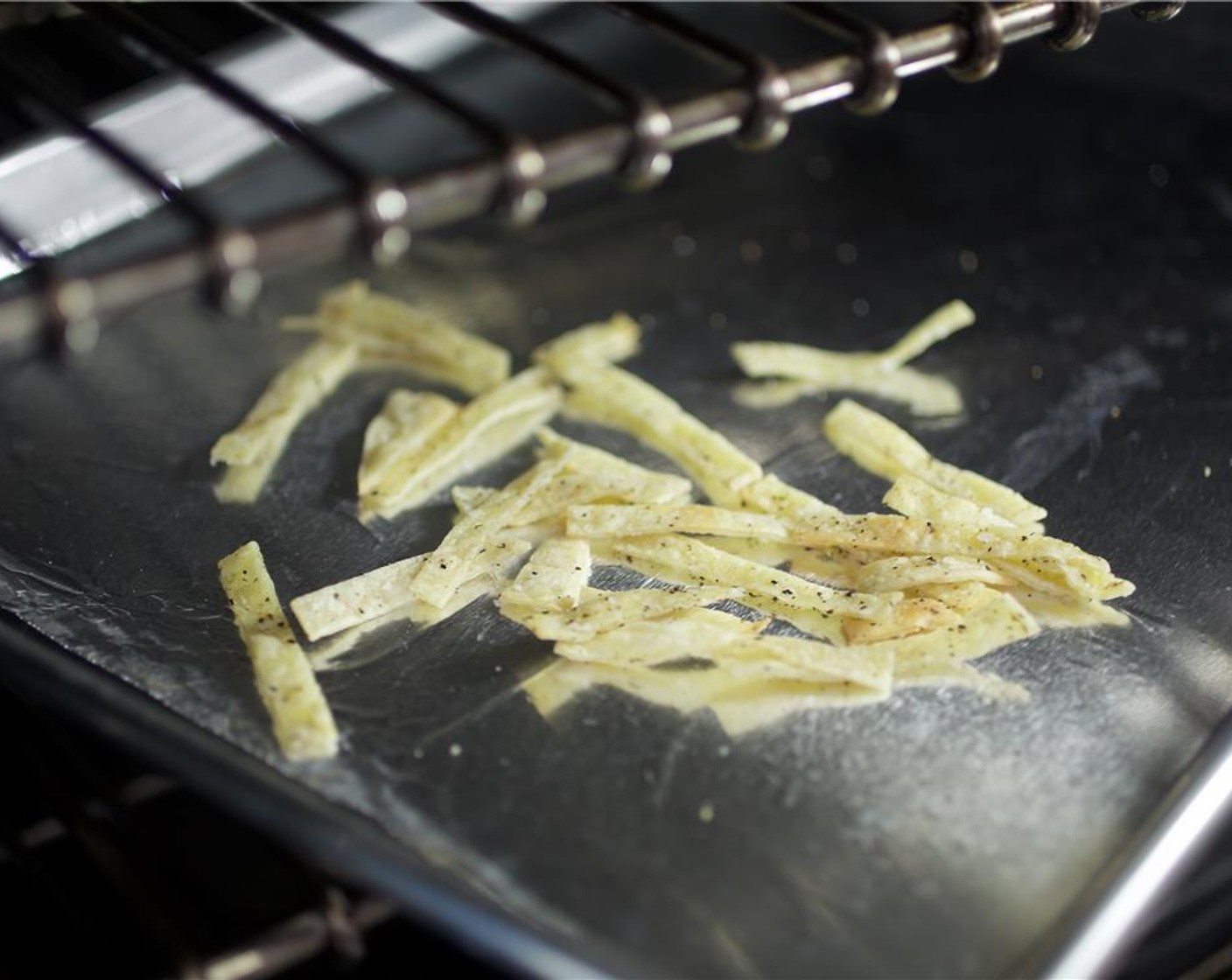 step 14 Toss strips and bake for another 5 minutes until crispy. Remove from oven and set aside.