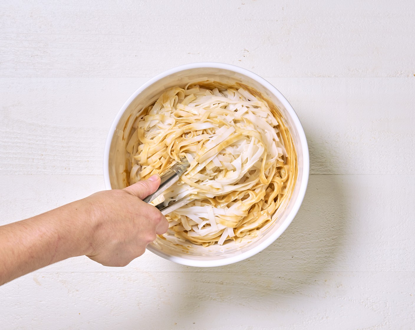 step 3 Drain the noodles carefully, and rinse in the sink using a colander until they have cooled down a little. Toss together in a large bowl with the dressing.