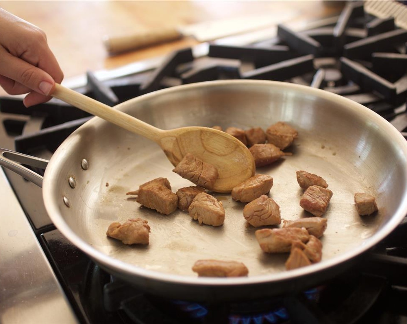 step 10 Transfer pork to a plate and set aside. In the same large saute pan, over high heat, add the remaining Sesame Oil (2 tsp) and heat.