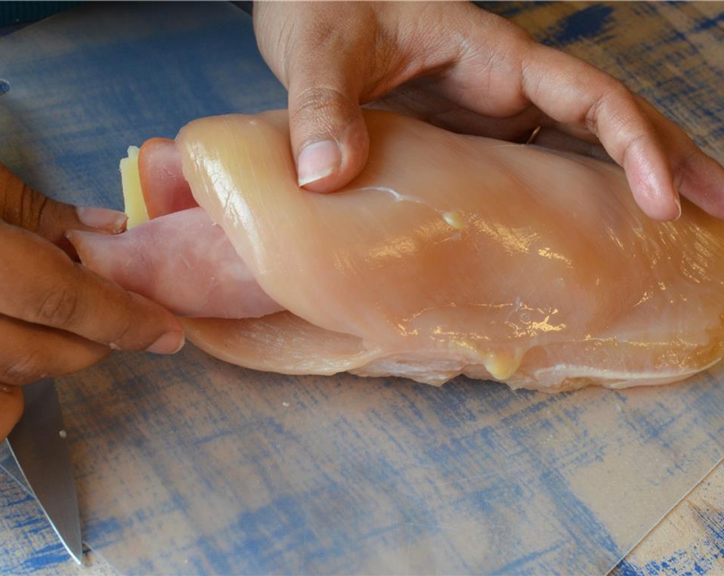 step 7 Stuff each chicken pocket with 1 or 2 ham rolls that were prepared earlier. Cut any excess that's sticking out off and press the pocket close.