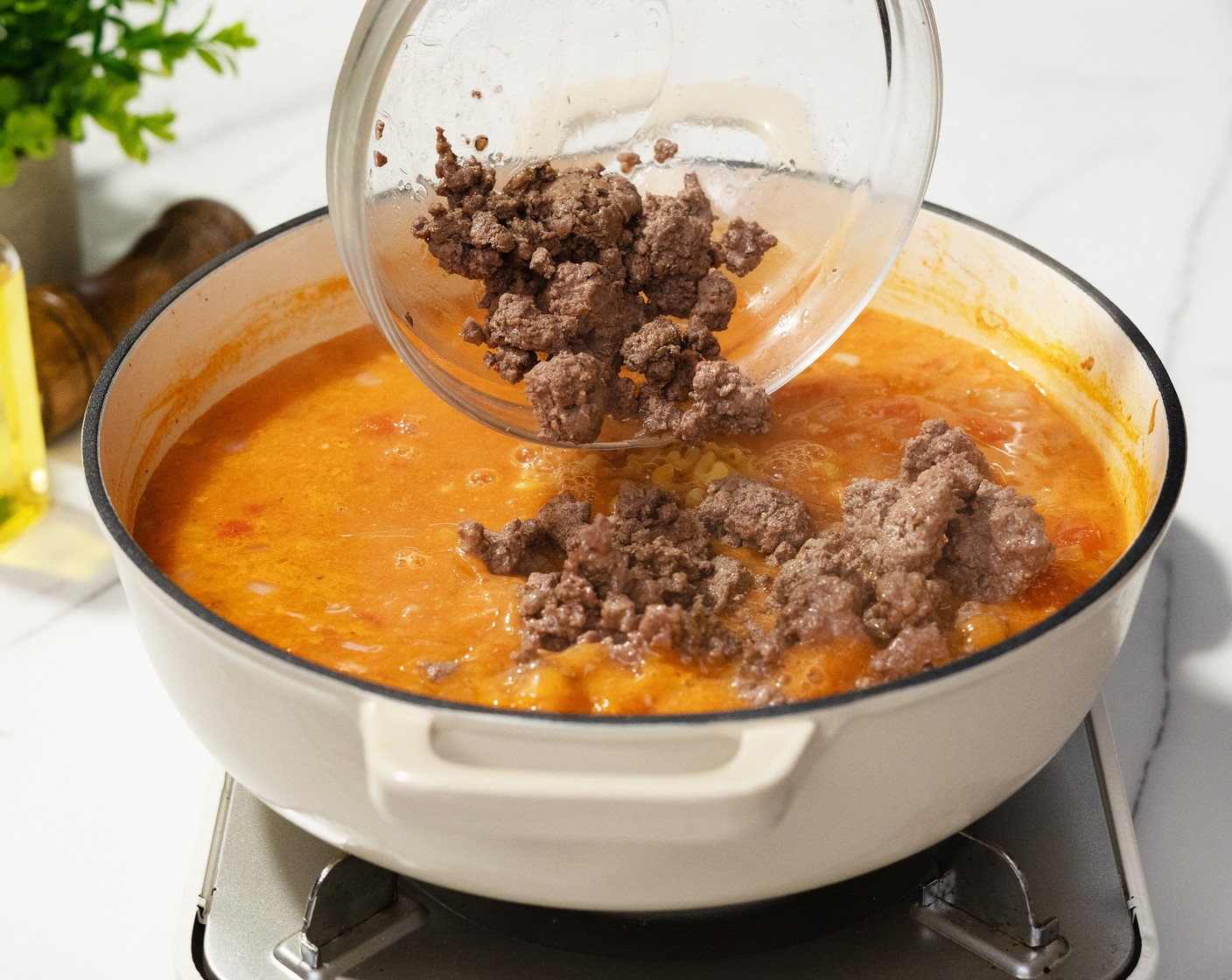 step 5 Add the Elbow Macaroni (1 cup) and the beef with juices. Cook for 10 minutes, or until the noodles are soft, stirring occasionally.