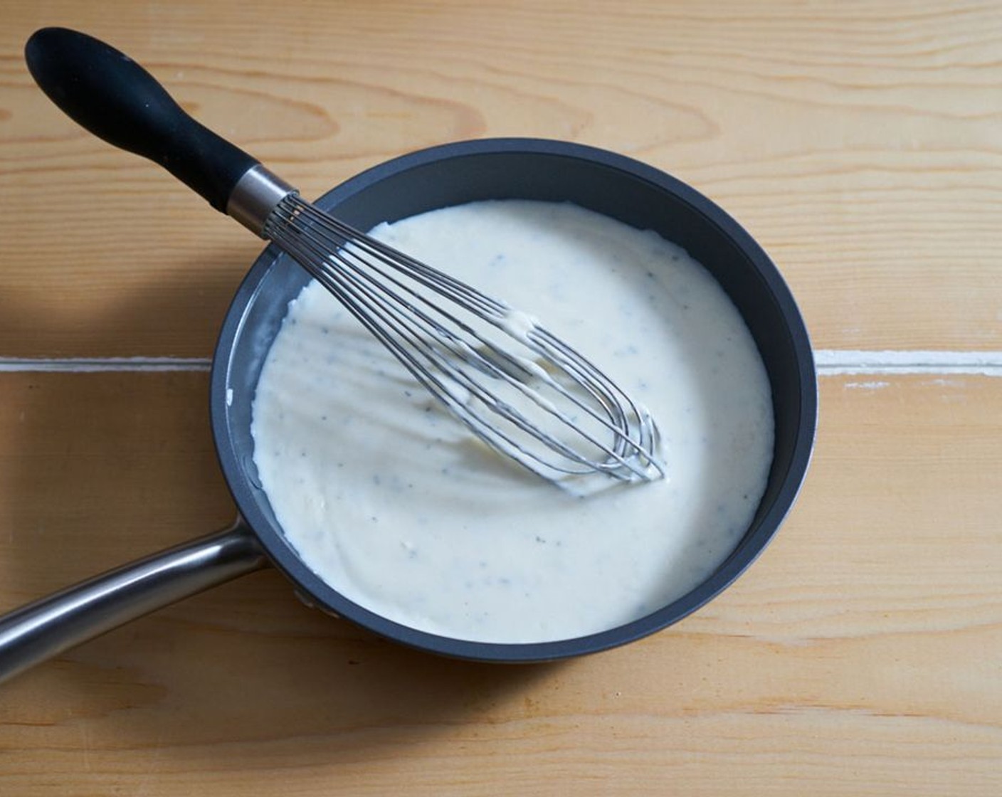 step 5 Gradually whisk in the Whole Milk (3 1/2 cups) so no lumps remain. Bring to a boil, then simmer for about 5 minutes until the mixture thickens and will coat the back of a spoon. Whisk in the Ground Nutmeg (1 pinch) and Fresh Sage (1 Tbsp), then season with Salt (to taste) and Ground Black Pepper (to taste).