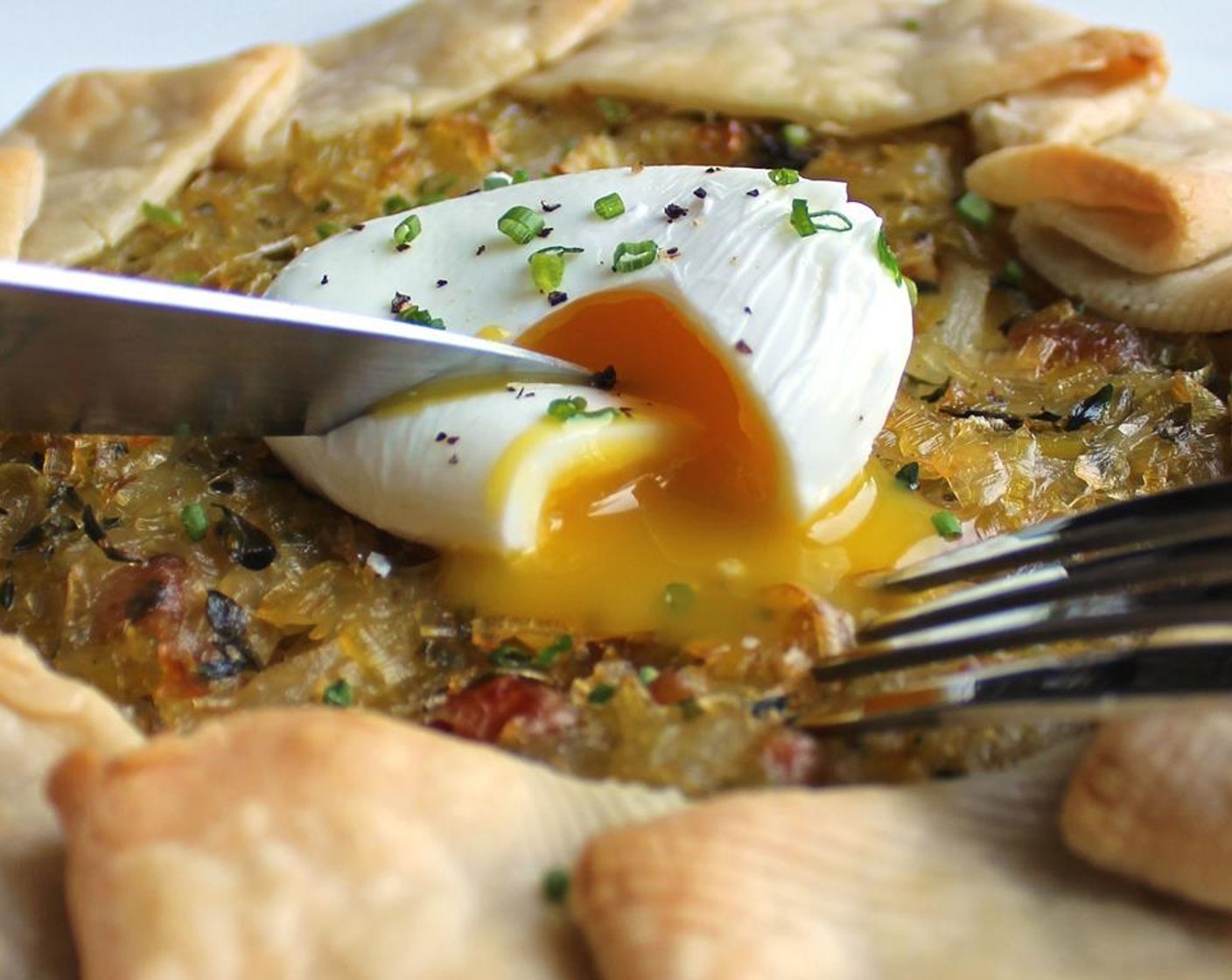 step 12 Place egg on top of cooked galette. Season with salt and pepper and leftover herbs.