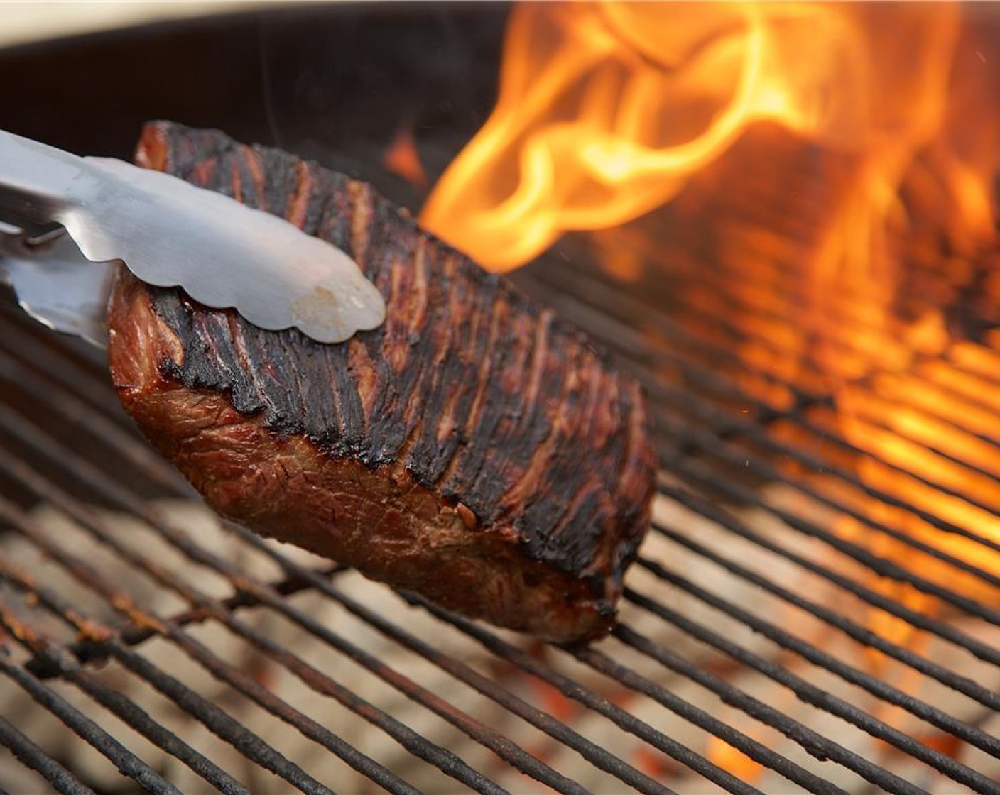 step 10 Place flank steak on the hottest side of the grill and cook on each side for two minutes each.