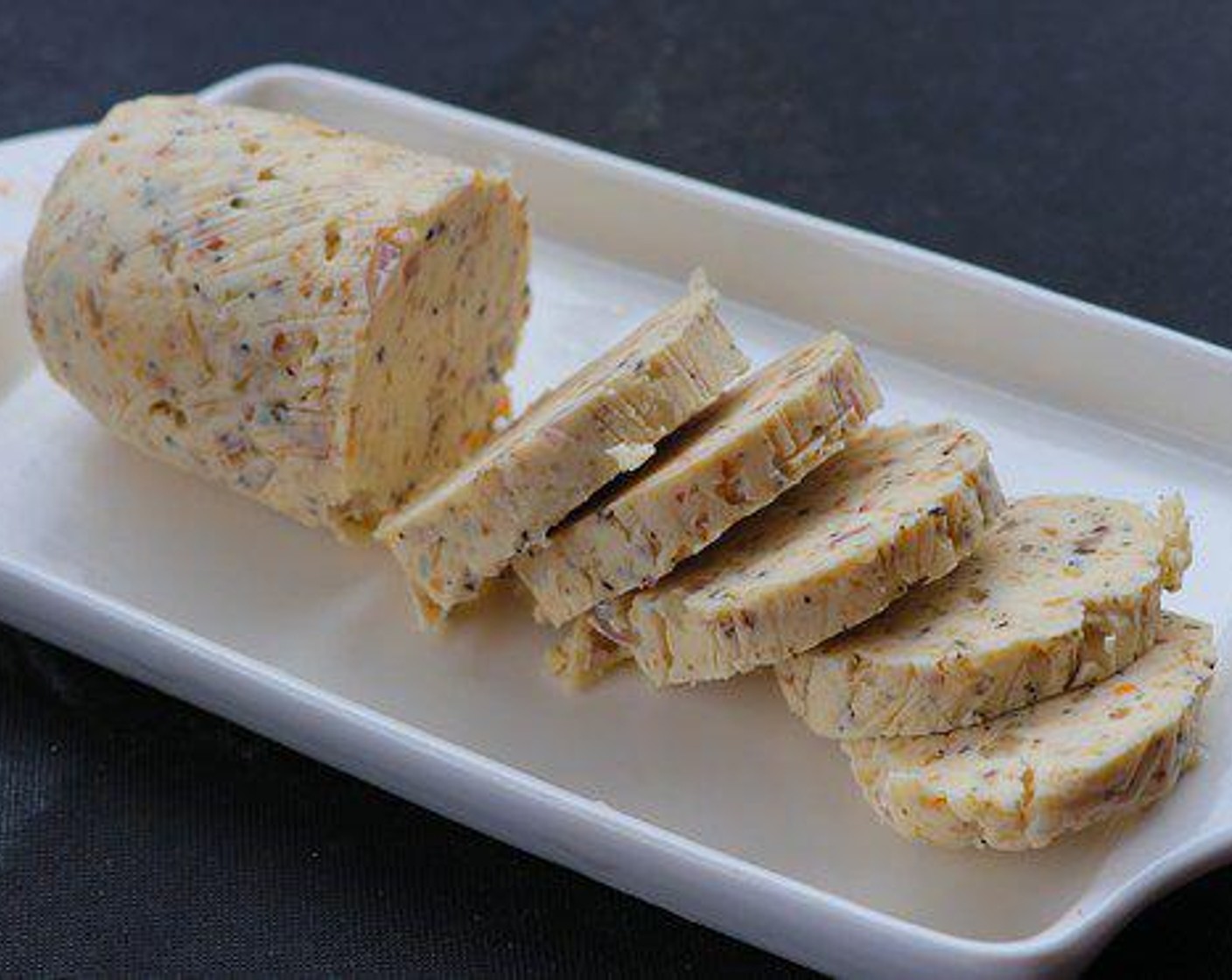 step 4 Combine Butter (1/2 cup), Shallot (1/2), Garlic (4 cloves), and Steak Spice Rub (1/2 Tbsp) in a small bowl. Spread the mixture onto plastic wrap and form a log shape. Wrap plastic wrap around the butter and store in the refrigerator for a couple of hours until firm. Slice into 1 Tablespoon portions.