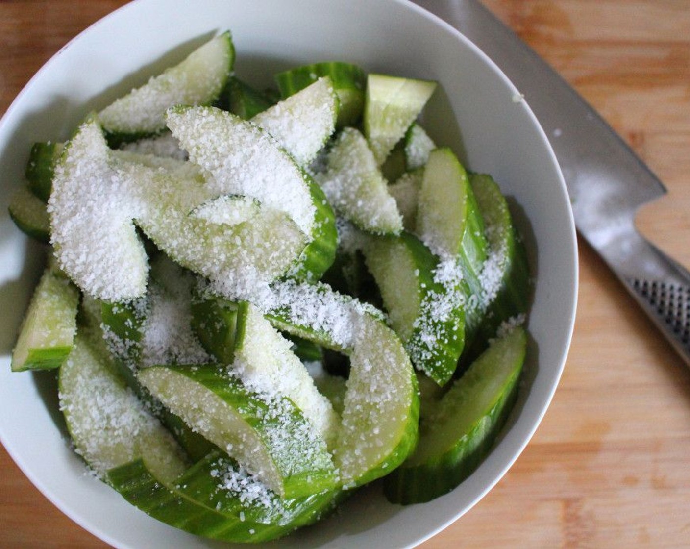 step 1 Cut Cucumber (1) lengthwise in half, then cut across into 1/3-inch slices. Add Kosher Salt (1 Tbsp), mix well and marinate for 1/2 hour, then discard the liquid.