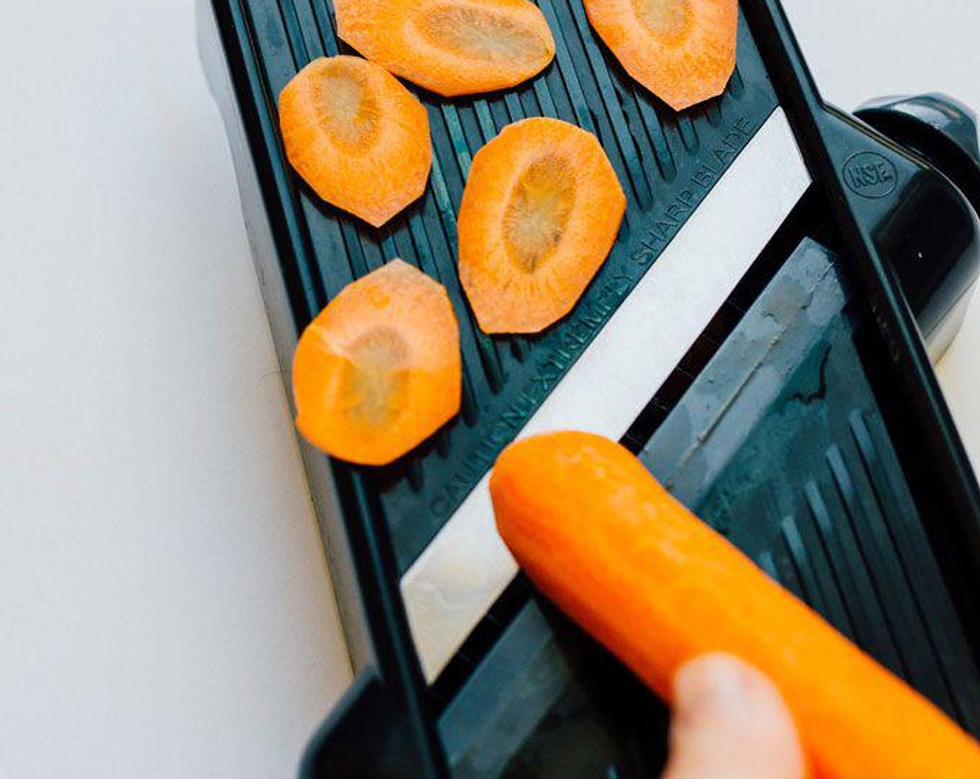 step 2 Thinly slice Carrot (1) into chips using a mandolin slicer.