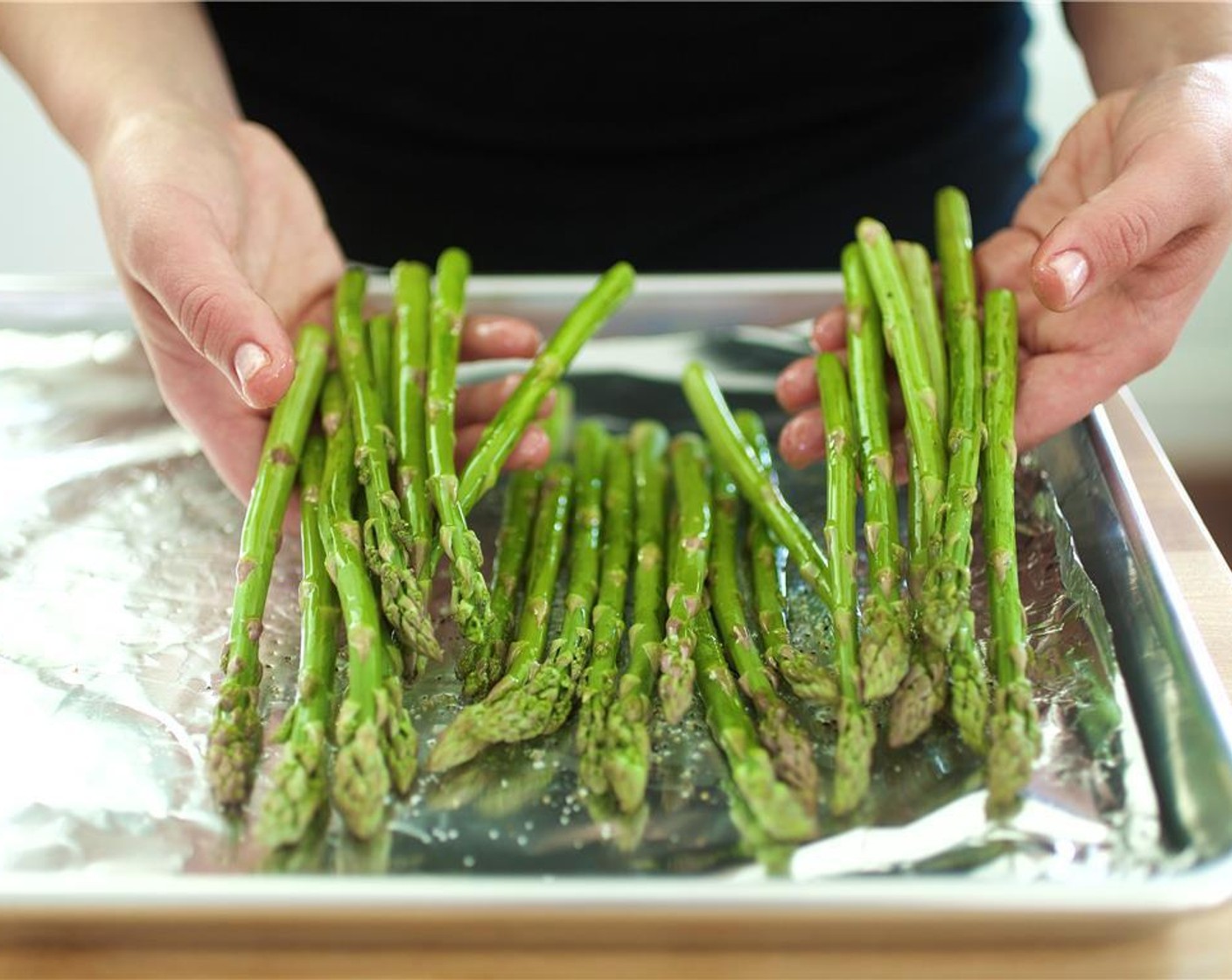 step 6 Place the asparagus in a single layer on half of a sheet pan, leaving room for the salmon. Drizzle the asparagus with Olive Oil (1 tsp), Salt (1/4 tsp) and Ground Black Pepper (1/4 tsp). Hold for next step.