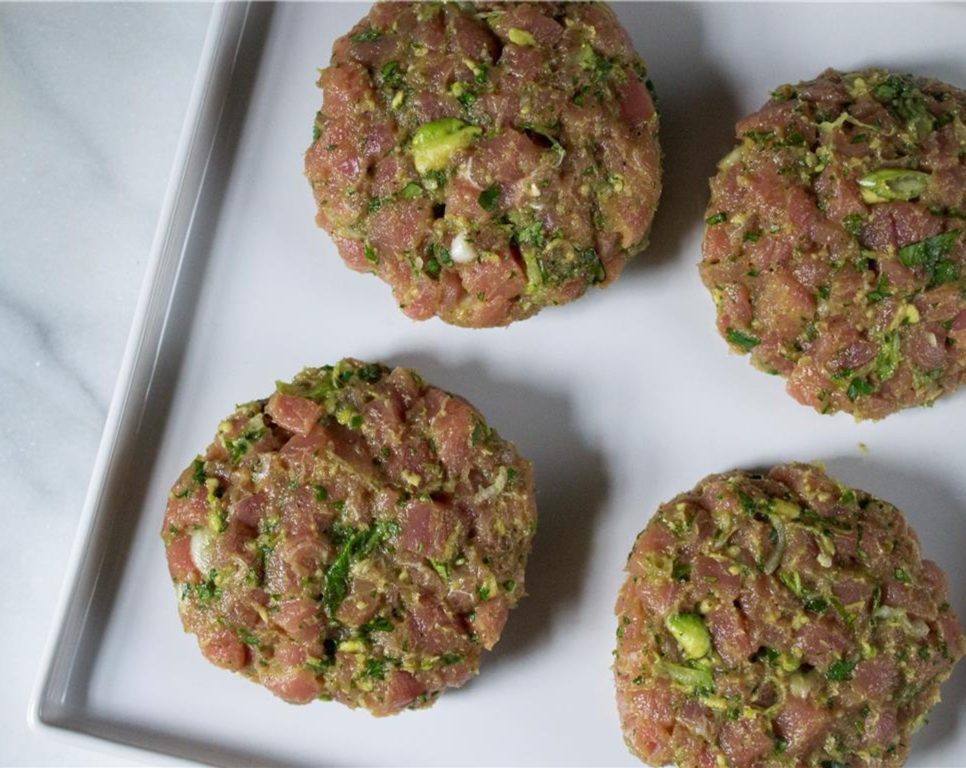 step 3 Divide the contents of the bowl into 4 equal portions and shape into 1-inch thick patties. Cover and refrigerate for 20 minutes and up to 2 hours.