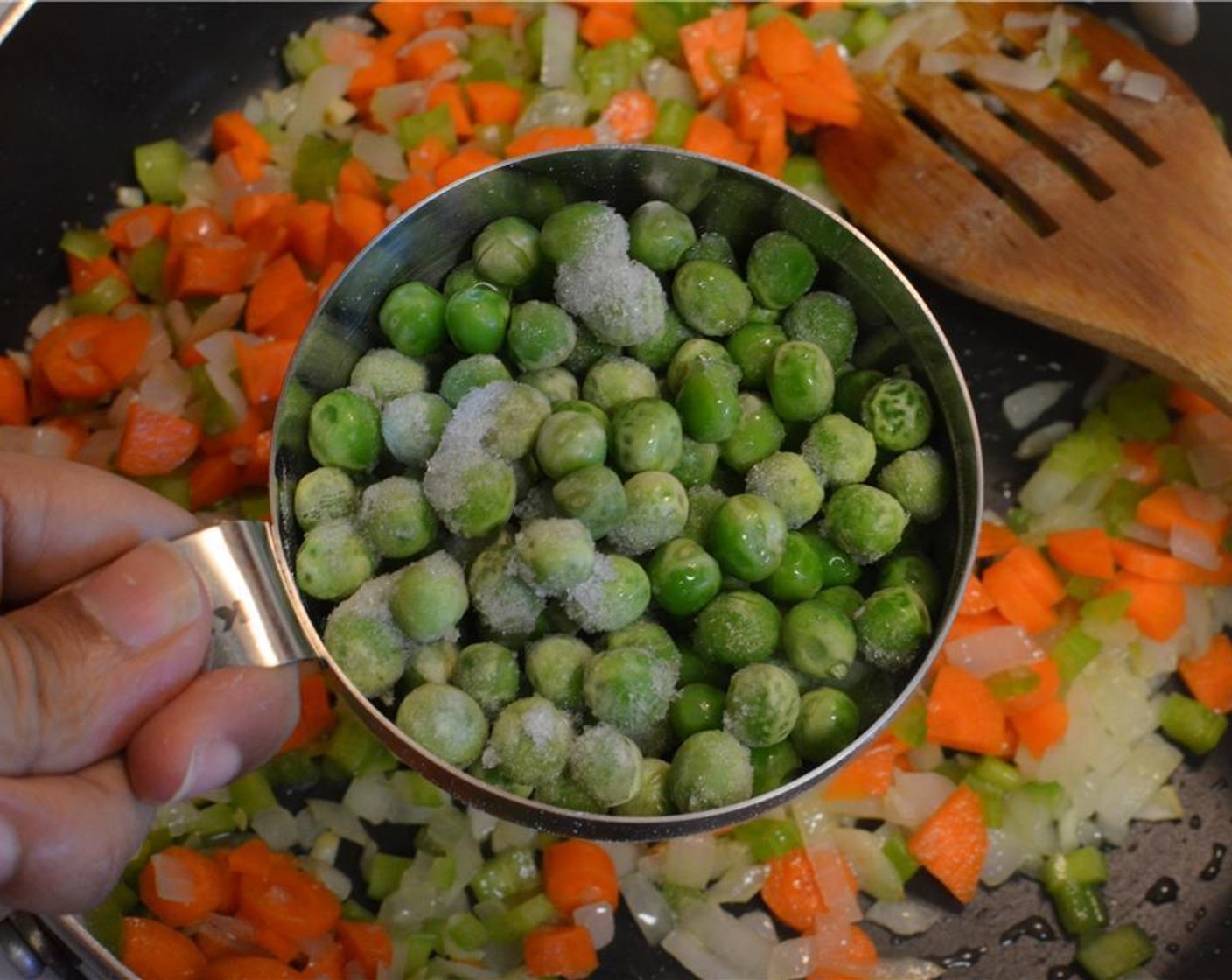 step 4 Add the finely diced Carrots (2), finely diced Celery (2 stalks) and Frozen Green Peas (3/4 cup) to the pan and mix together.