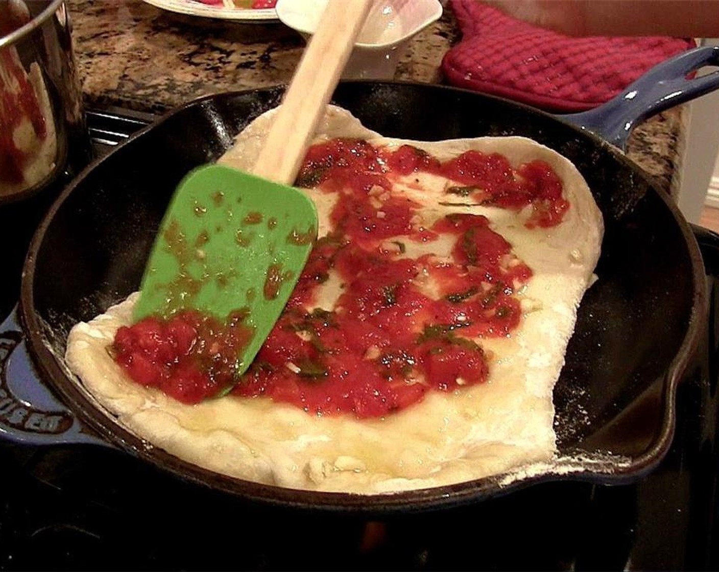step 12 Immediately spread half the the cooked tomato sauce onto the pizza dough in a thick layer.