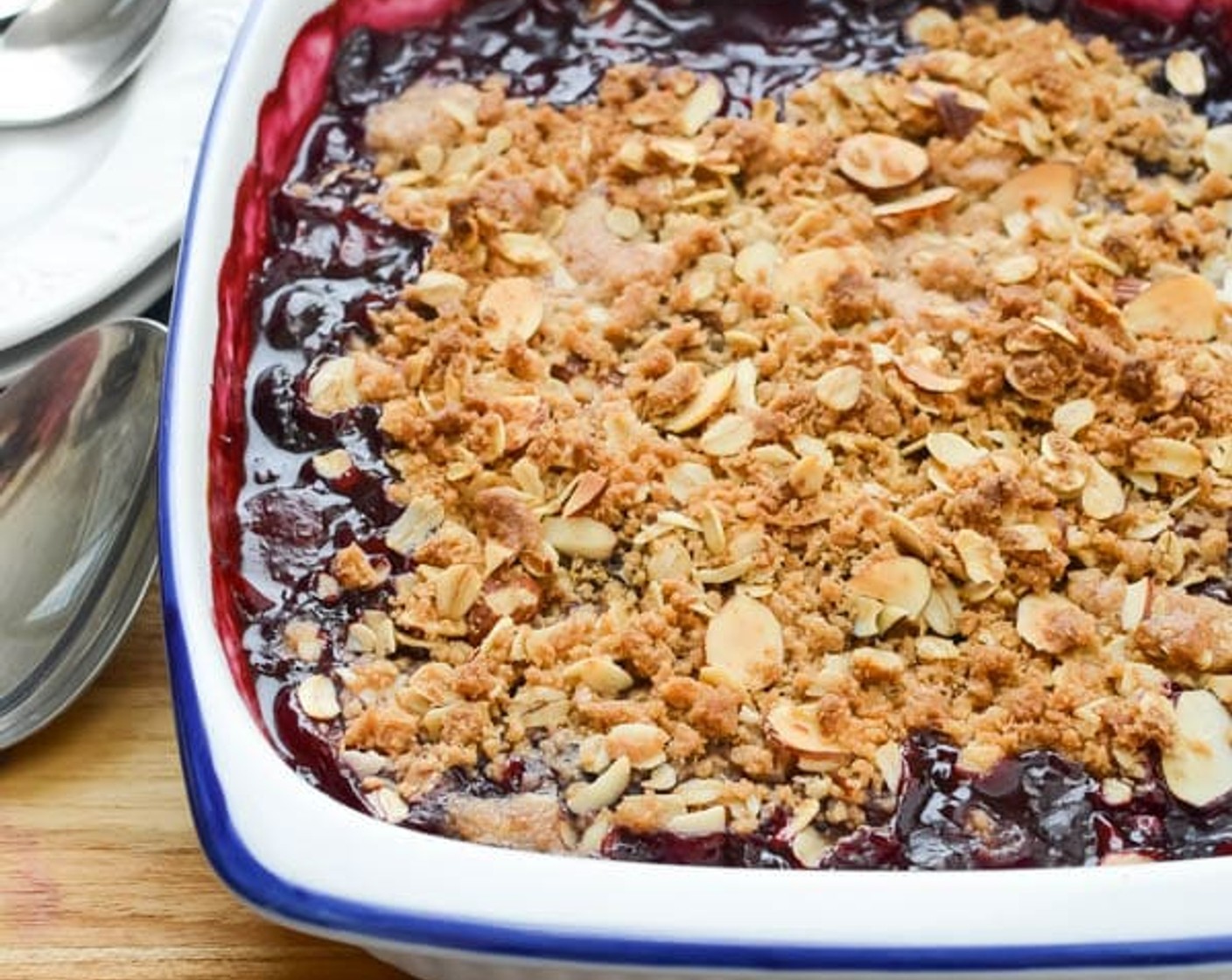 step 5 Transfer the fruit mixture to an 8×8 ceramic baking dish. Sprinkle the streusel topping over the fruit. Bake for 15 minutes, then turn the dish around 180° in the oven.  Bake for another 10 minutes until the fruit is bubbly and syrupy and the topping is evenly browned.