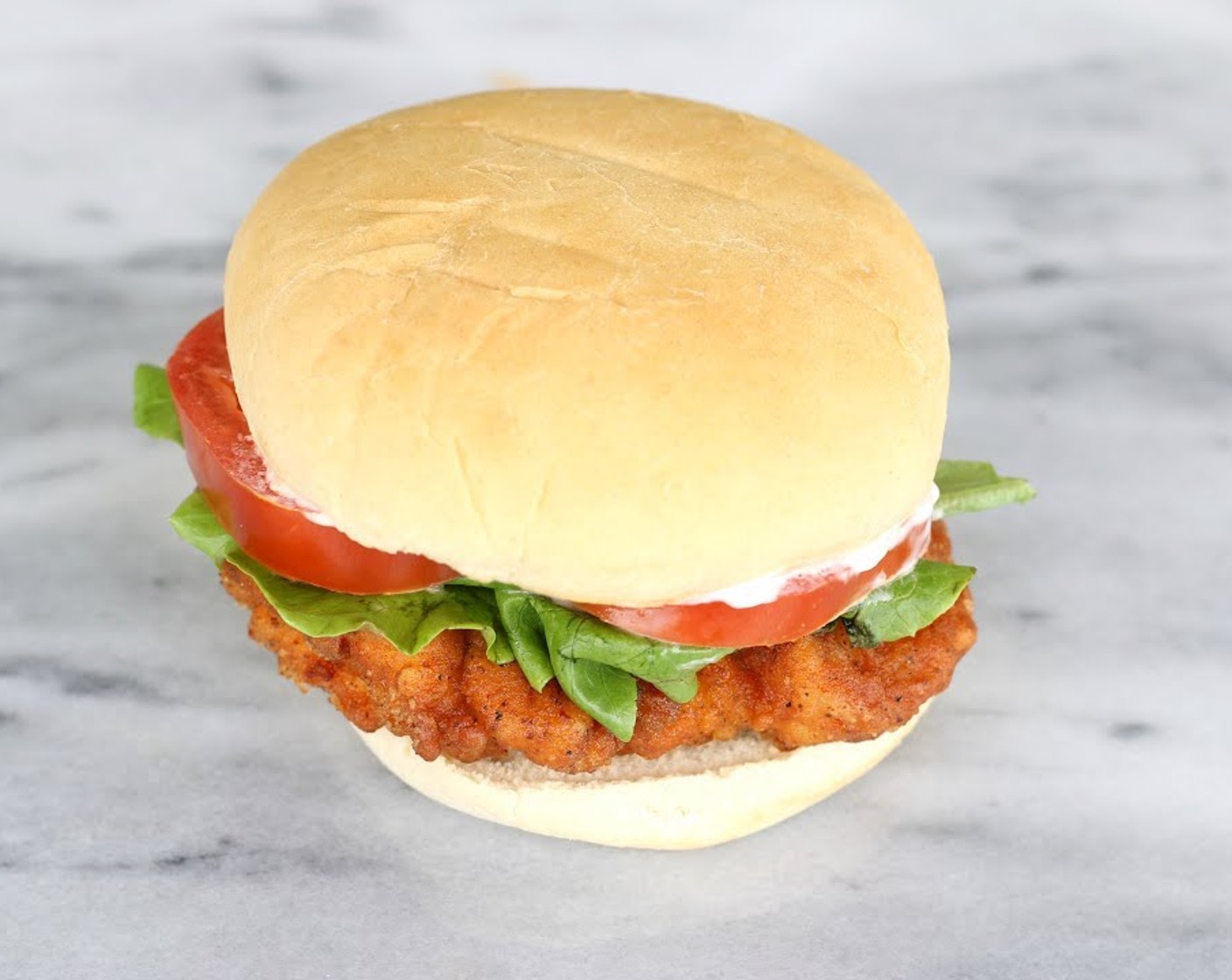 step 6 Drain off the excess oil from the fillets. Arrange the fillets, sliced Tomato (1), and Lettuce Leaves (4) inside your Hamburger Buns (4). top with some Mayonnaise (to taste), and serve!