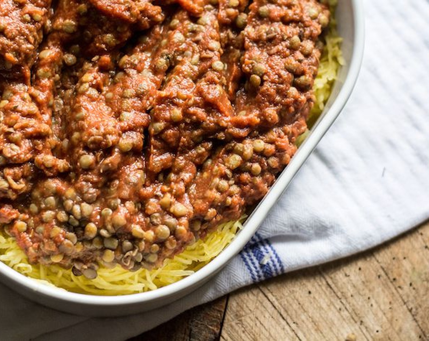 step 10 Layer spaghetti squash into 9x13 pan (or equivalent), then top with lentil and sauce mixture, followed by Romano Cheese (2/3 cup) and Fresh Parsley (to taste).