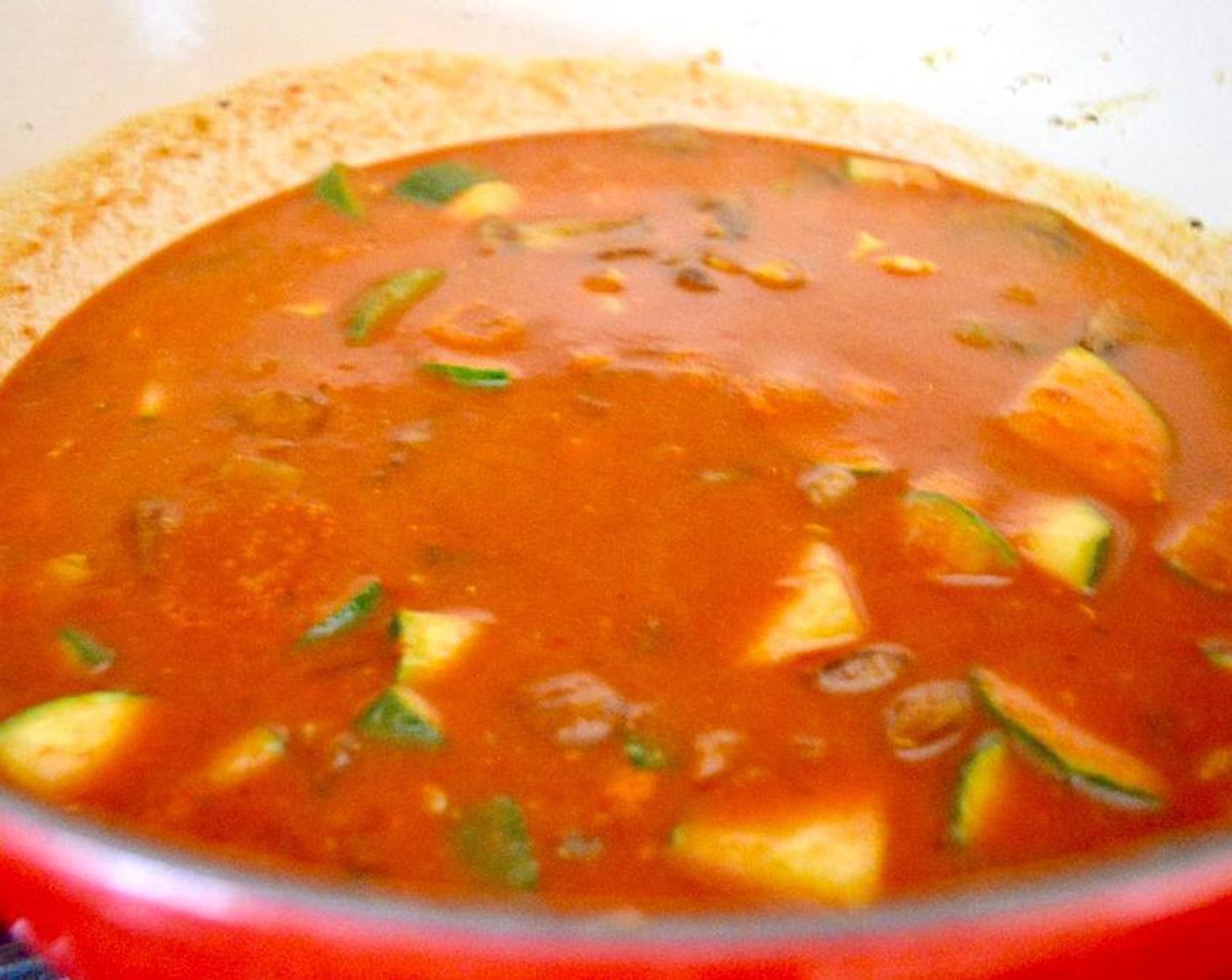 step 3 Once it finishes cooking, pour in the Red Wine (4 Tbsp) and let it cook off for another 3 minutes. Finally, pour in the Crushed Tomatoes (1 can), Chicken Stock (1 1/2 cups), and Milk (1/2 cup).