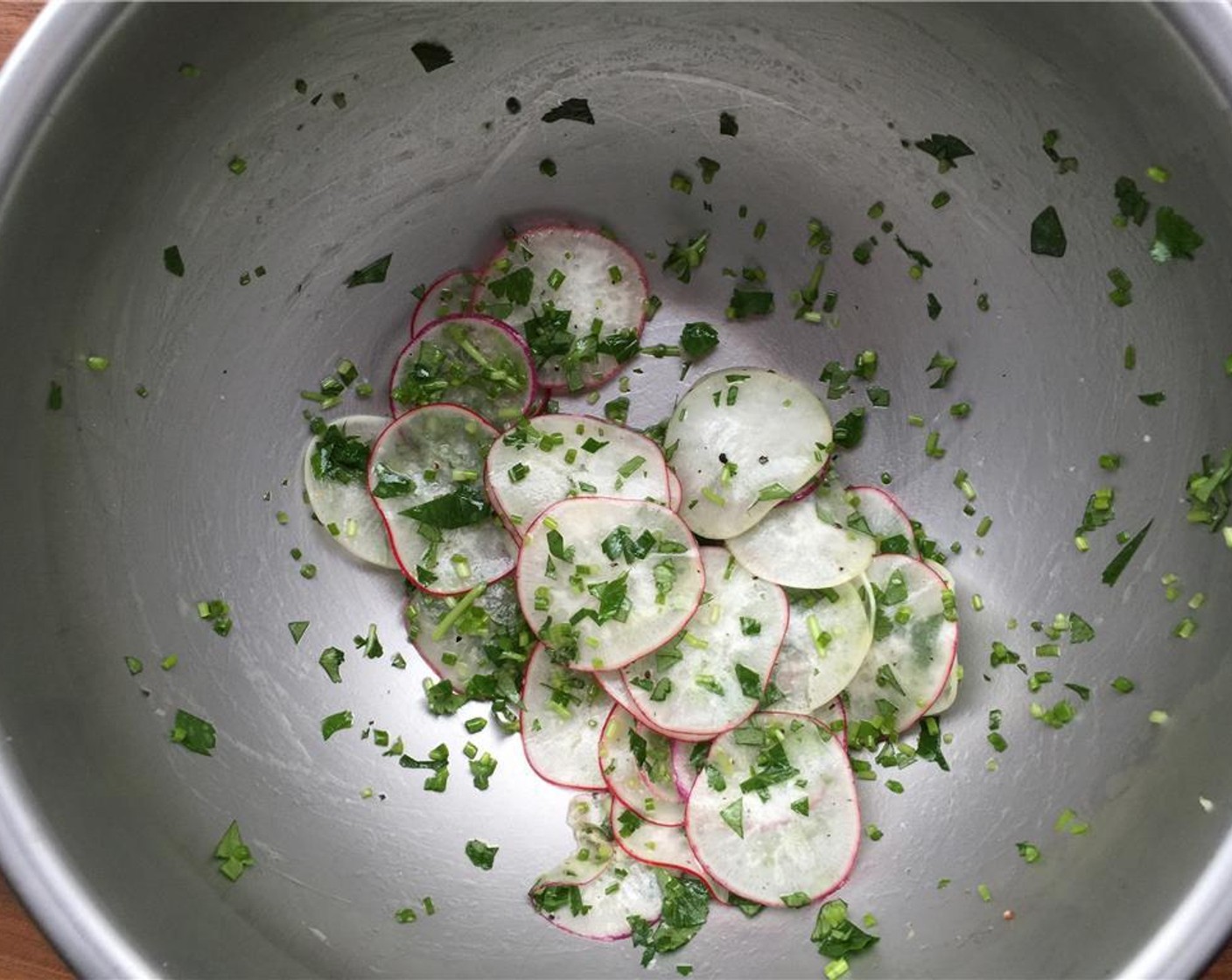 step 9 In a small bowl toss together the Radish (1 cup), Fresh Chives (1/4 cup), Italian Flat-Leaf Parsley (1/4 cup), Kosher Salt (to taste), Freshly Ground Black Pepper (to taste), juice from Lemon (1) and Extra-Virgin Olive Oil (1 Tbsp).