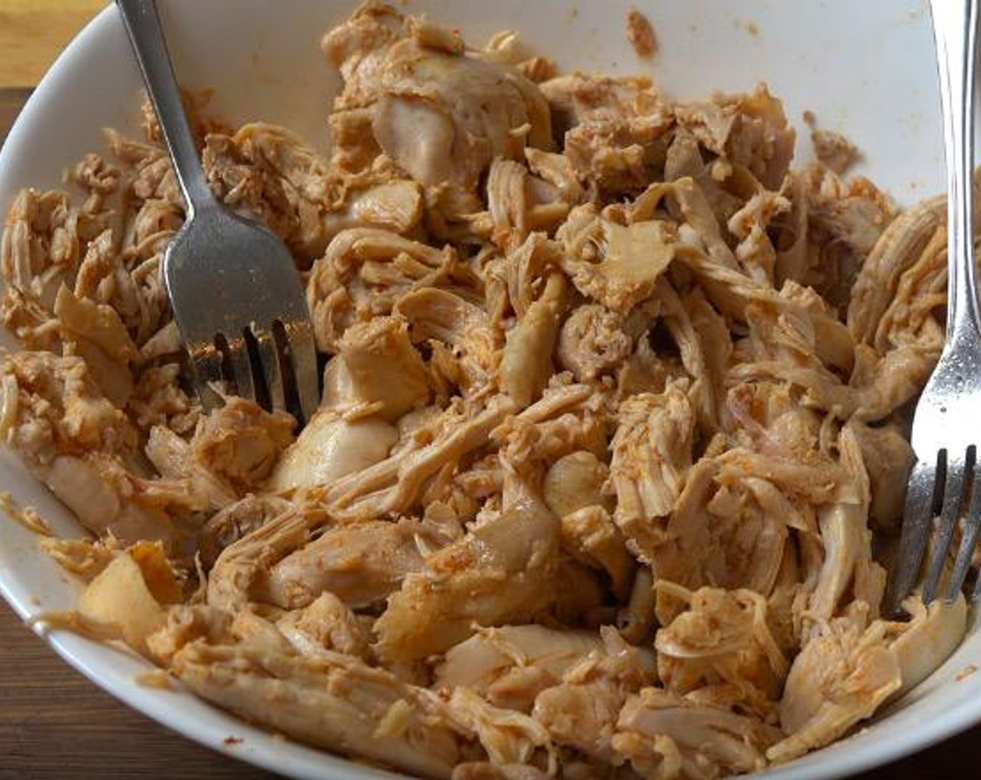 step 3 Transfer the chicken to a large bowl. Using two forks, shred the chicken into small pieces. Return to pan.