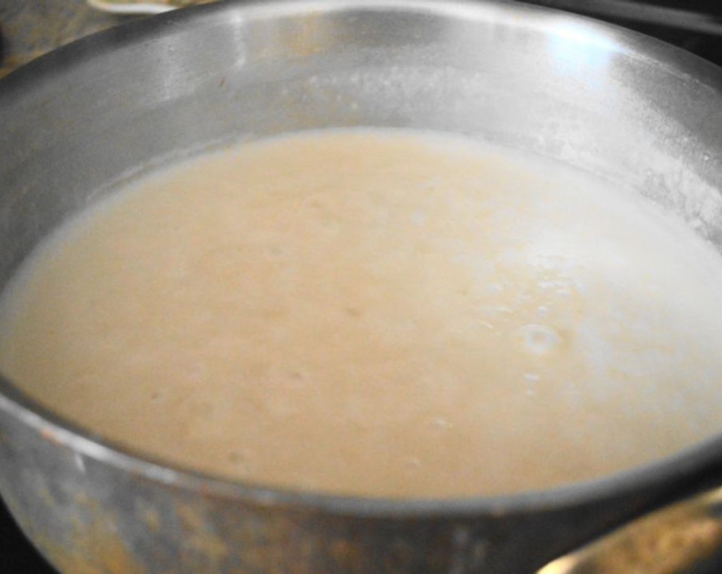 step 8 Once the bechamel sauce has cooked for 15 minutes, whisk in Sharp Cheddar Cheese (1 cup), Smoked Gruyere Cheese (1/2 cup), and Smoked Gouda (1/2 cup) until it becomes a smooth, rich sauce. Stir in the sliced bratwurst as well and let the mixture bubble together for a minute.