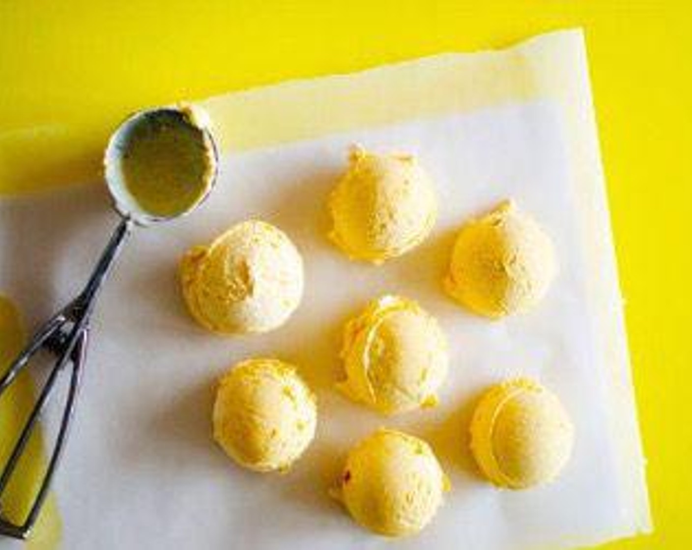 step 5 Repeat 6 to 8 times, or for as many cookies as you have, placing scoops on a parchment paper-lined plate. Place in freezer to harden until you're ready to assemble.
