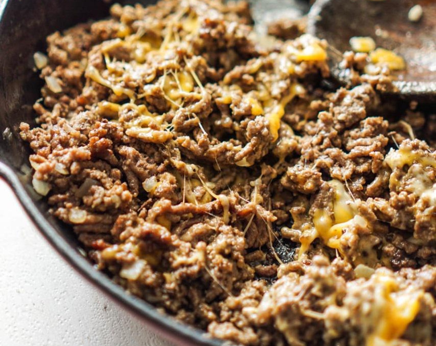 step 4 Add American Cheese Slices (4) to cover the beef. Allow to melt for a minute, then stir to incorporate into the ground beef.