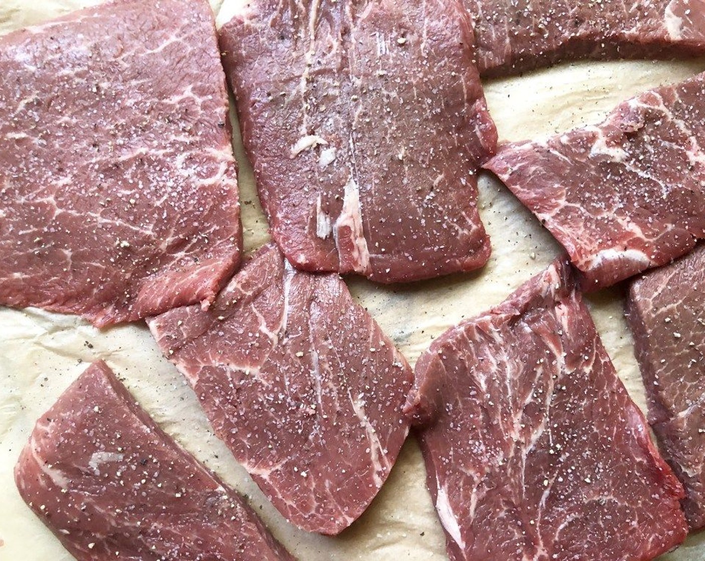 step 2 Season Flat Iron Steak (2.5 lb) generously with Kosher Salt (to taste) and Freshly Ground Black Pepper (to taste). In a large Dutch oven or heavy ovenproof pot, heat the Olive Oil (2 Tbsp) over moderately high heat.