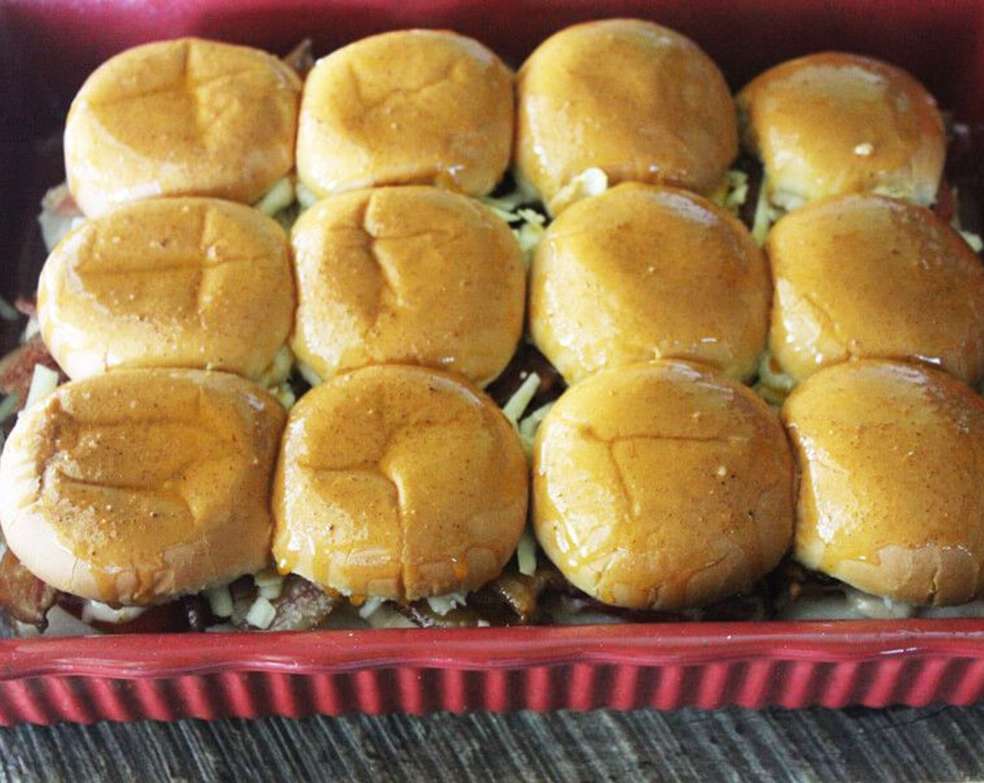 step 9 Brush the remaining butter and spice mixture on top of the buns, then place in the oven uncovered for 15 - 20 minutes until the cheese is melted and the tops are golden brown.