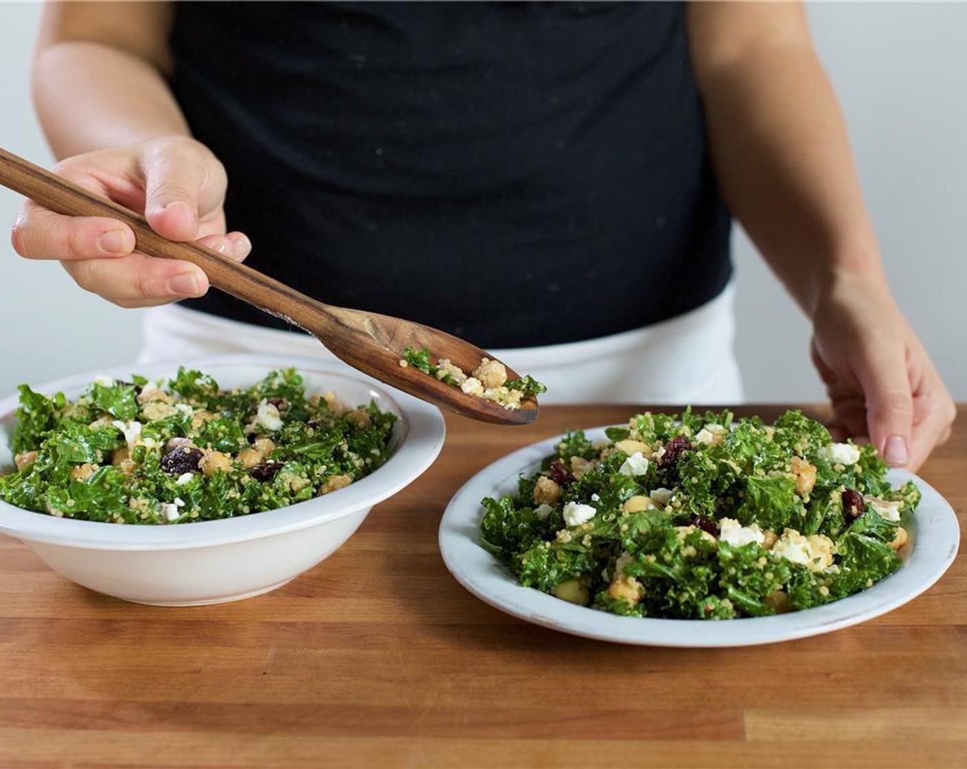 step 12 In the center of two bowls place the quinoa salad. Garnish with remaining Goat Cheese (4 Tbsp).