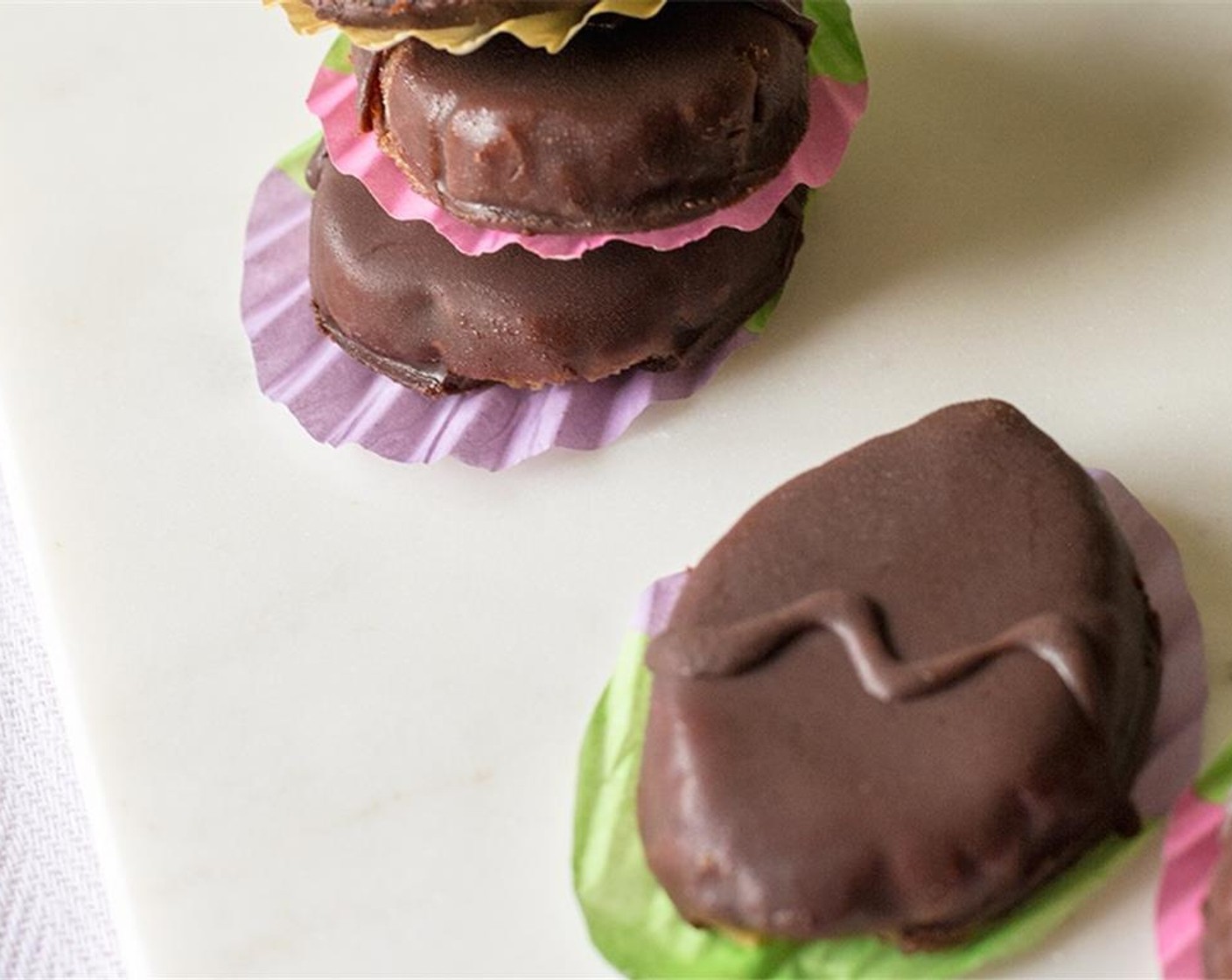 step 7 Remove eggs from freezer, dip each egg into the chocolate coating, making sure to fully cover. Allow excess chocolate to drip off, then place back on lined baking sheet, chocolate will begin to harden almost immediately.