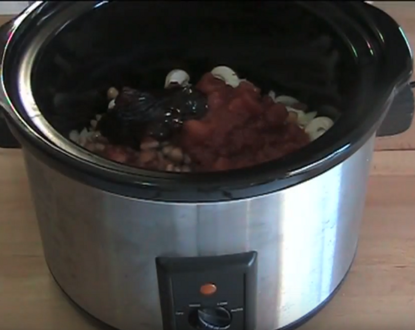 step 1 To start, brown Sausages (8) in a frying pan. Add browned sausage bits to the slow cooker. Add Bacon (2 slices), Button Mushrooms (8), Yellow Onion (1), Canned Three Bean Mix (1 3/4 cups), Canned Diced Tomatoes (1 3/4 cups), and Barbecue Sauce (2 Tbsp).
