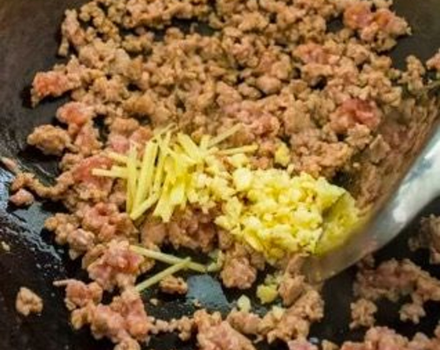 step 4 When the pork is about halfway cooked, add Garlic (2 cloves) and Fresh Ginger (1/2 in). Stir-fry until the pork is cooked all the way through.